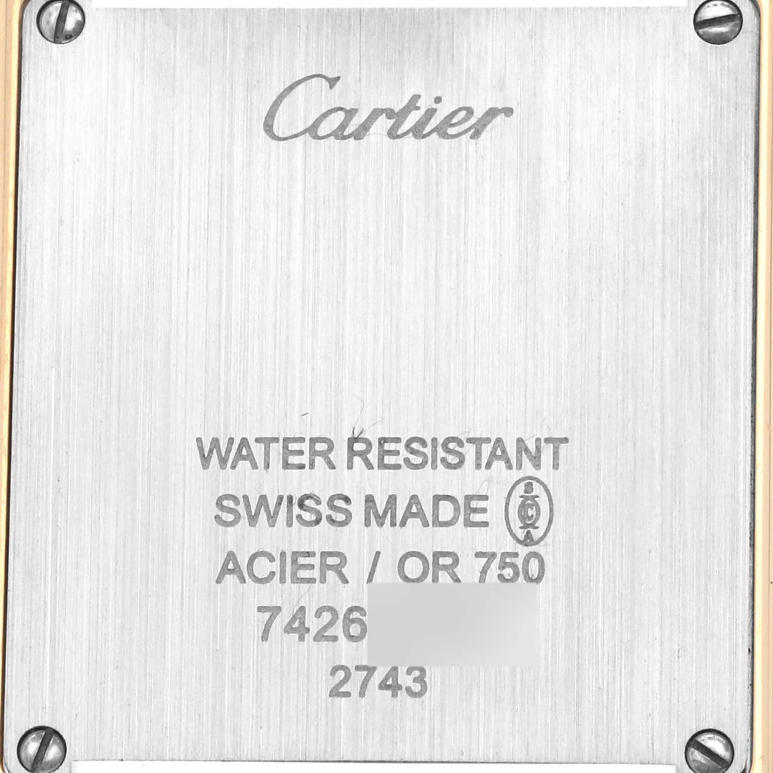 The image shows a close-up of the back case of a Cartier Tank Solo W1018755 Women
s Steel and Gold (two tone) Silver Dial W1018755 Women
s Steel and Gold (two tone) Silver Dial watch, displaying the brand and model details.