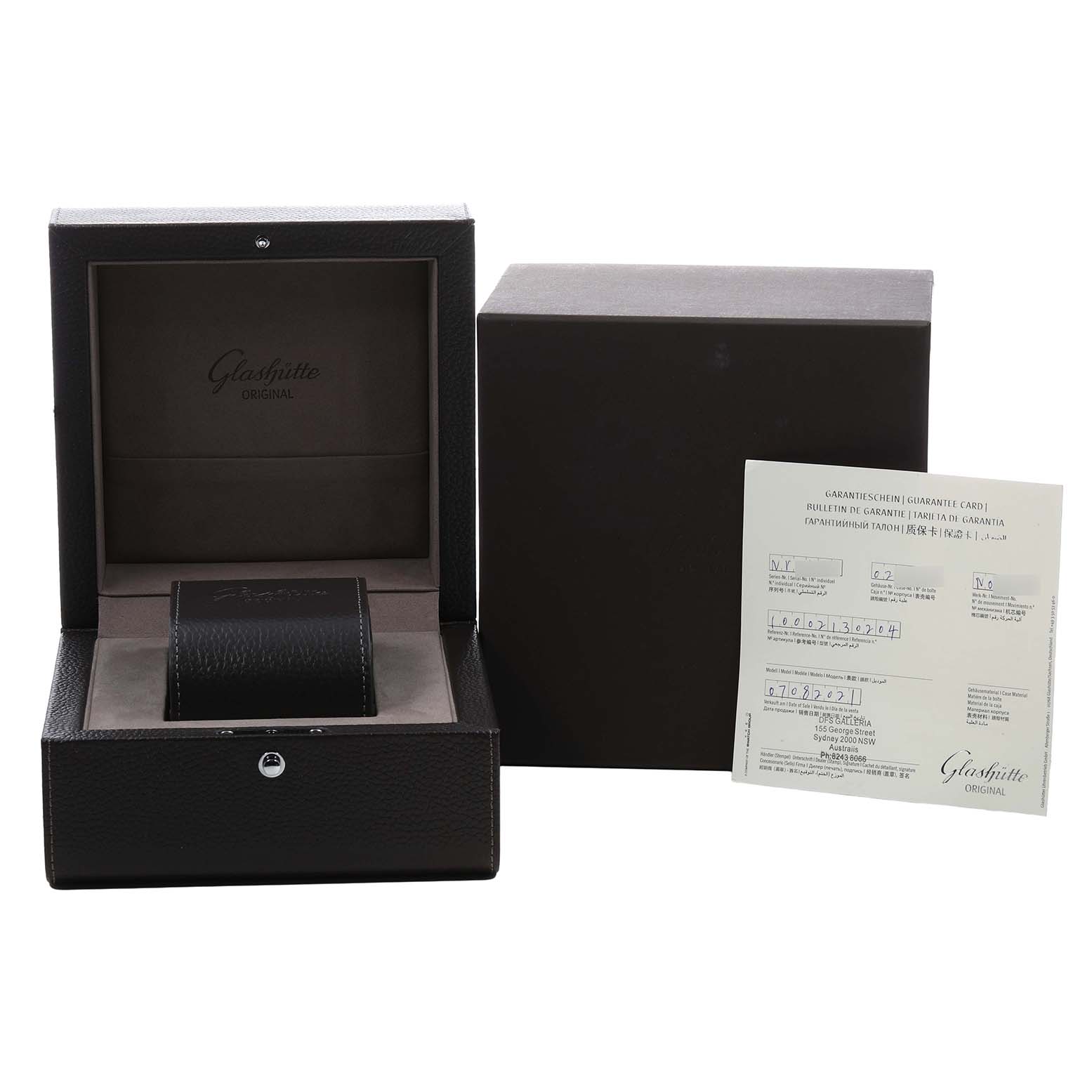 The image shows a Glashütte Original watch box open, alongside a warranty card and outer packaging.