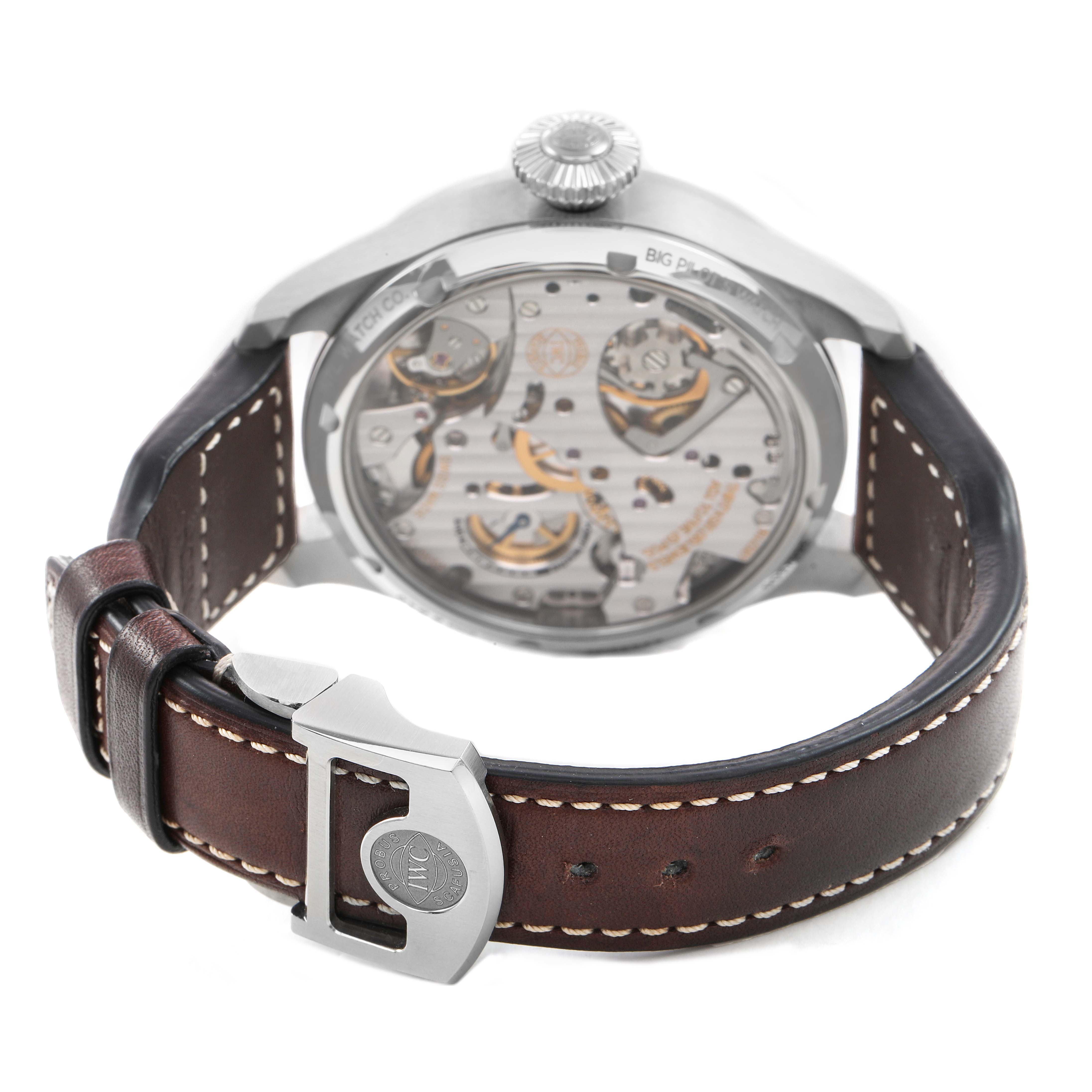 The IWC Pilot IW515202 Men's Stainless Steel Blue Dial model watch is shown from the back, highlighting the movement and brown leather strap with contrast stitching.
