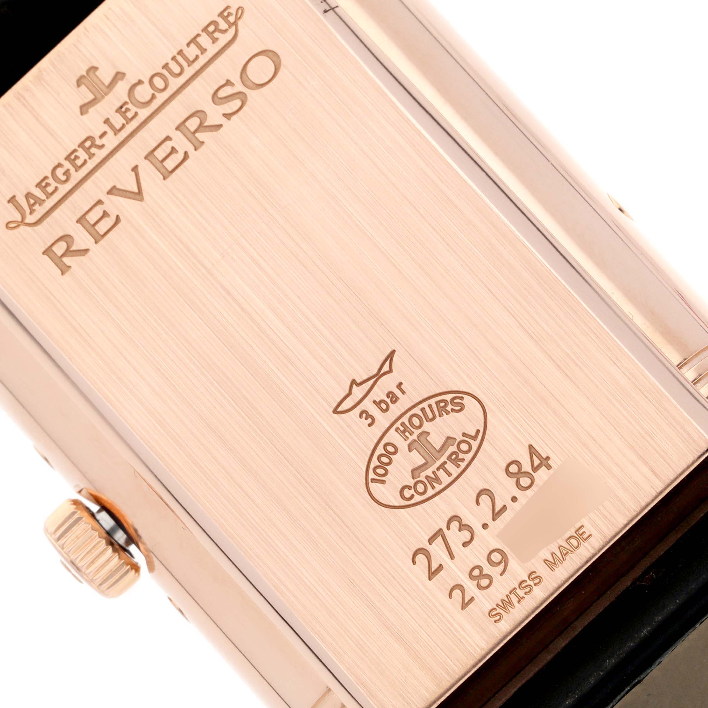 The image shows the back case of a Jaeger-LeCoultre Reverso watch, highlighting its inscriptions and crown.