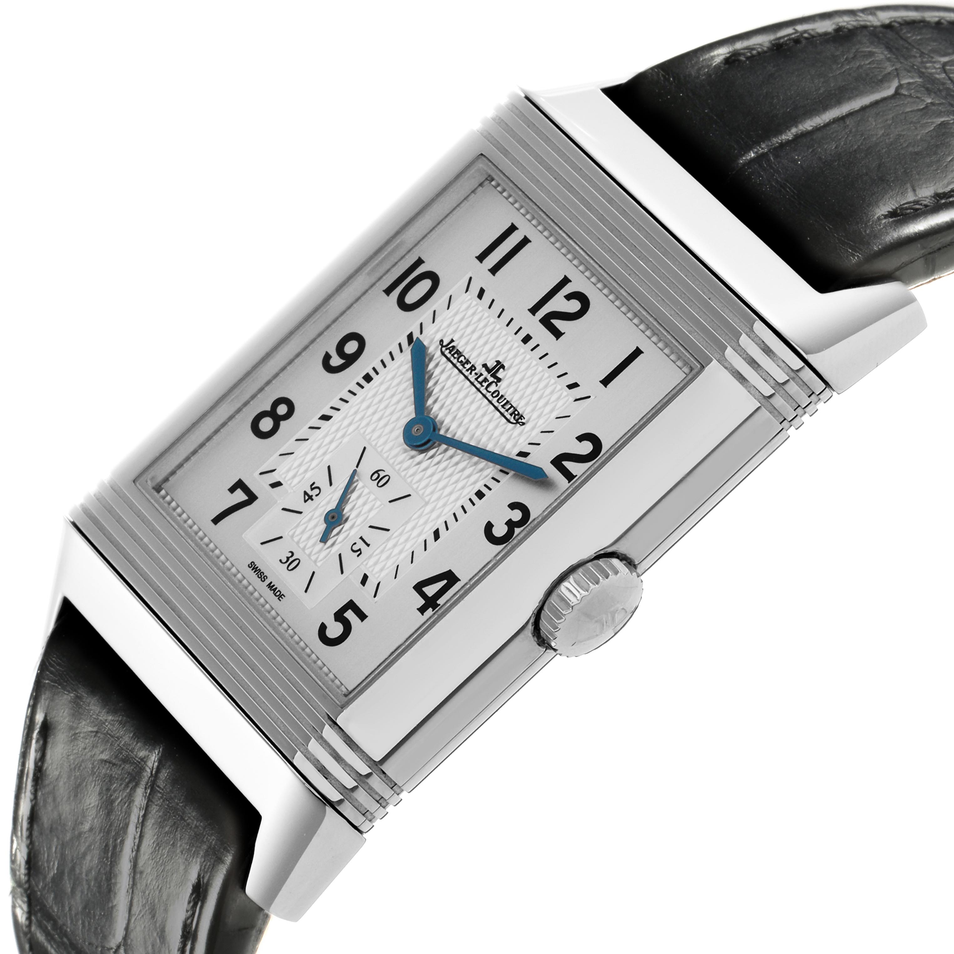 The Jaeger-LeCoultre Reverso watch is shown at a tilted angle, displaying the dial, crown, and leather strap.
