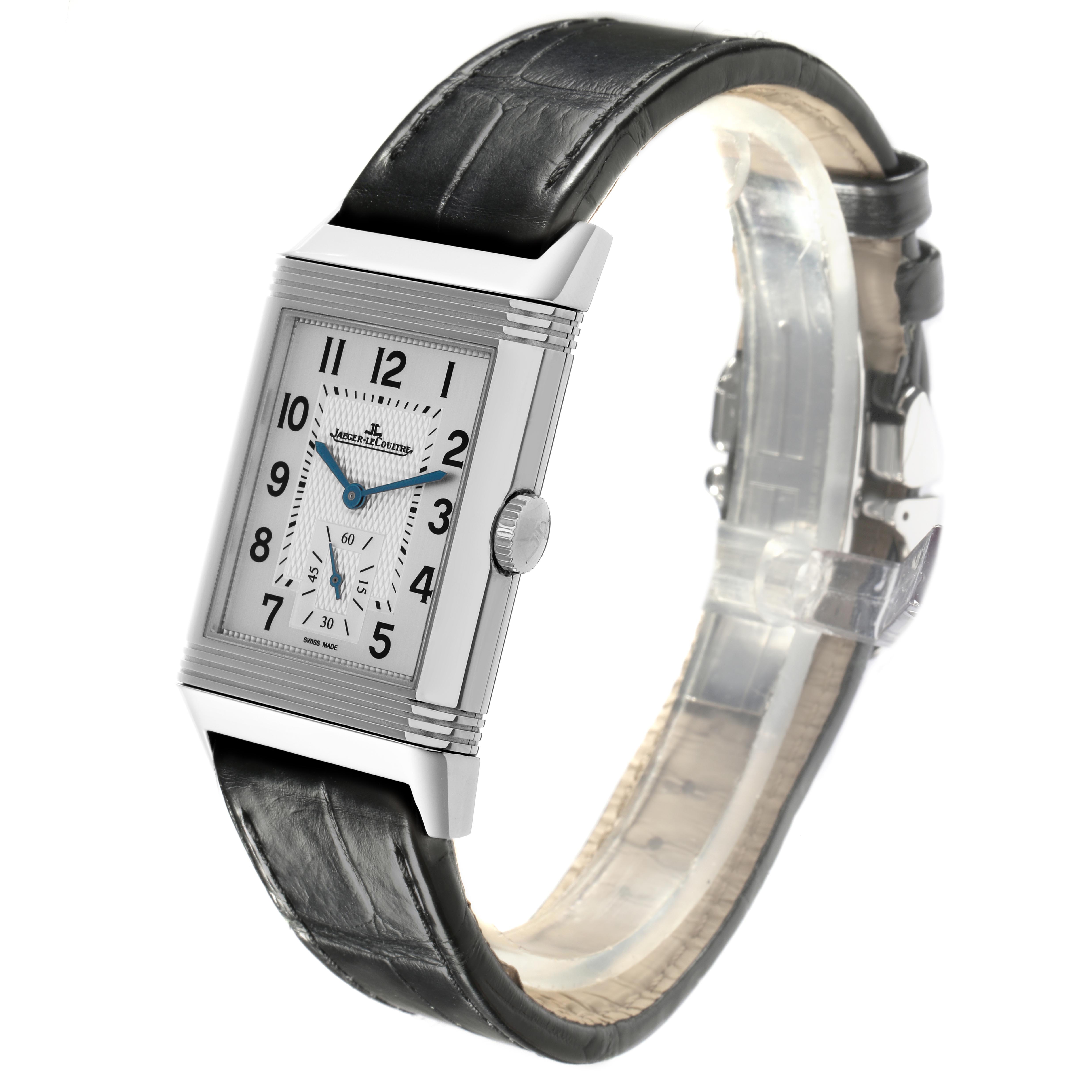 The Jaeger-LeCoultre Reverso watch is shown at an angled side view, highlighting the rectangular face, crown, and black leather strap.
