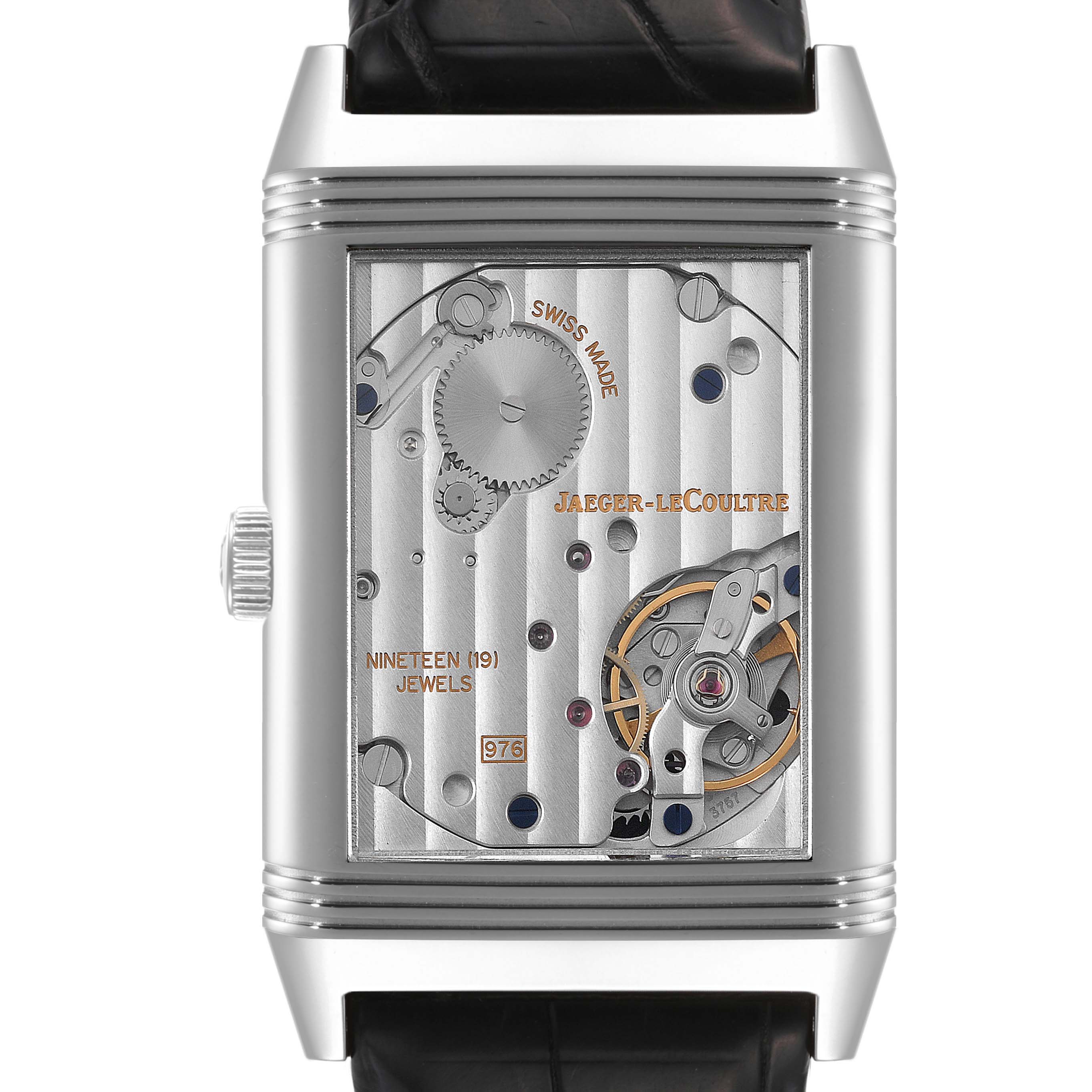 The image shows the back of the Jaeger-LeCoultre Reverso watch, revealing its mechanical movement and internal components.