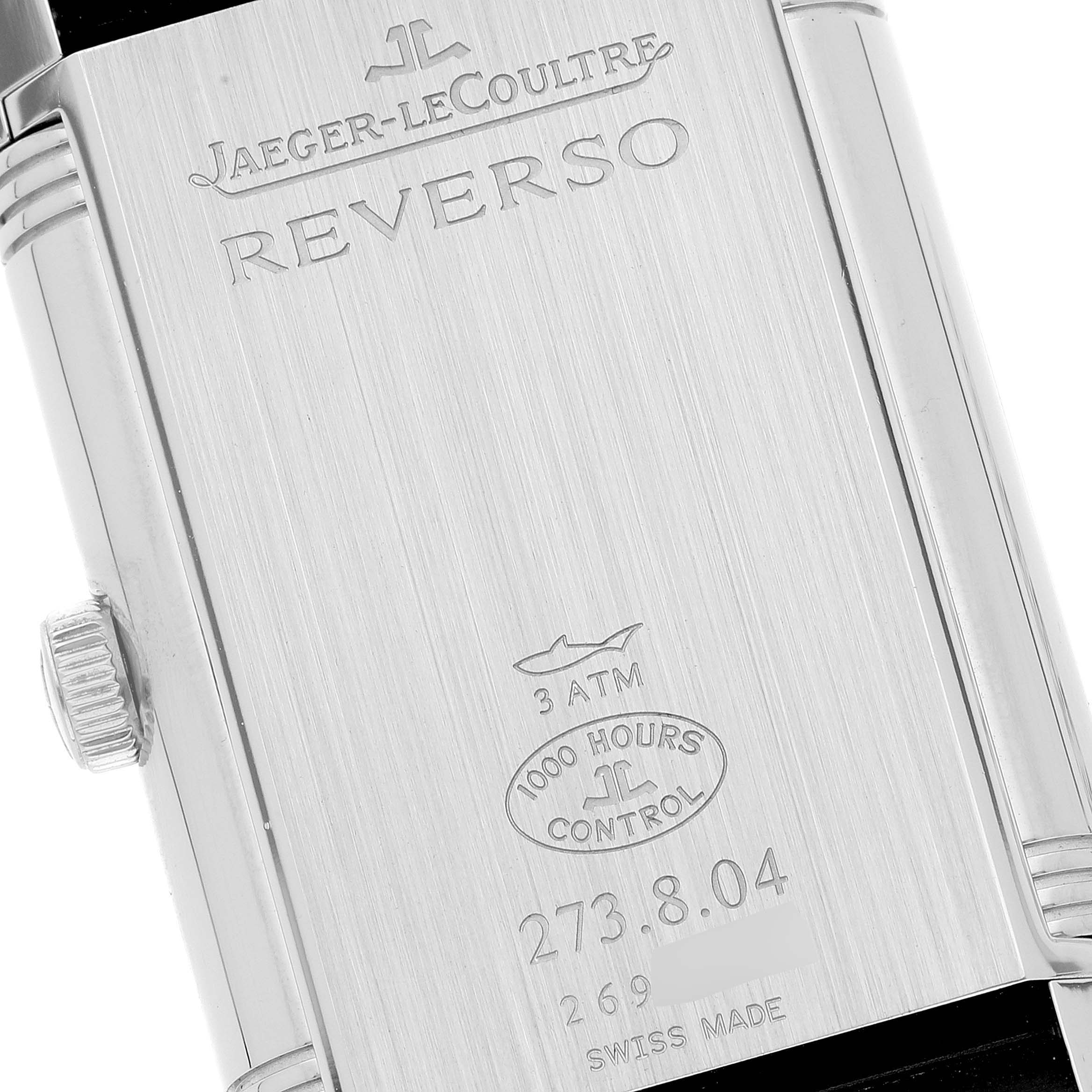 This image shows the back case of a Jaeger-LeCoultre Reverso watch, displaying engraving and specifications.