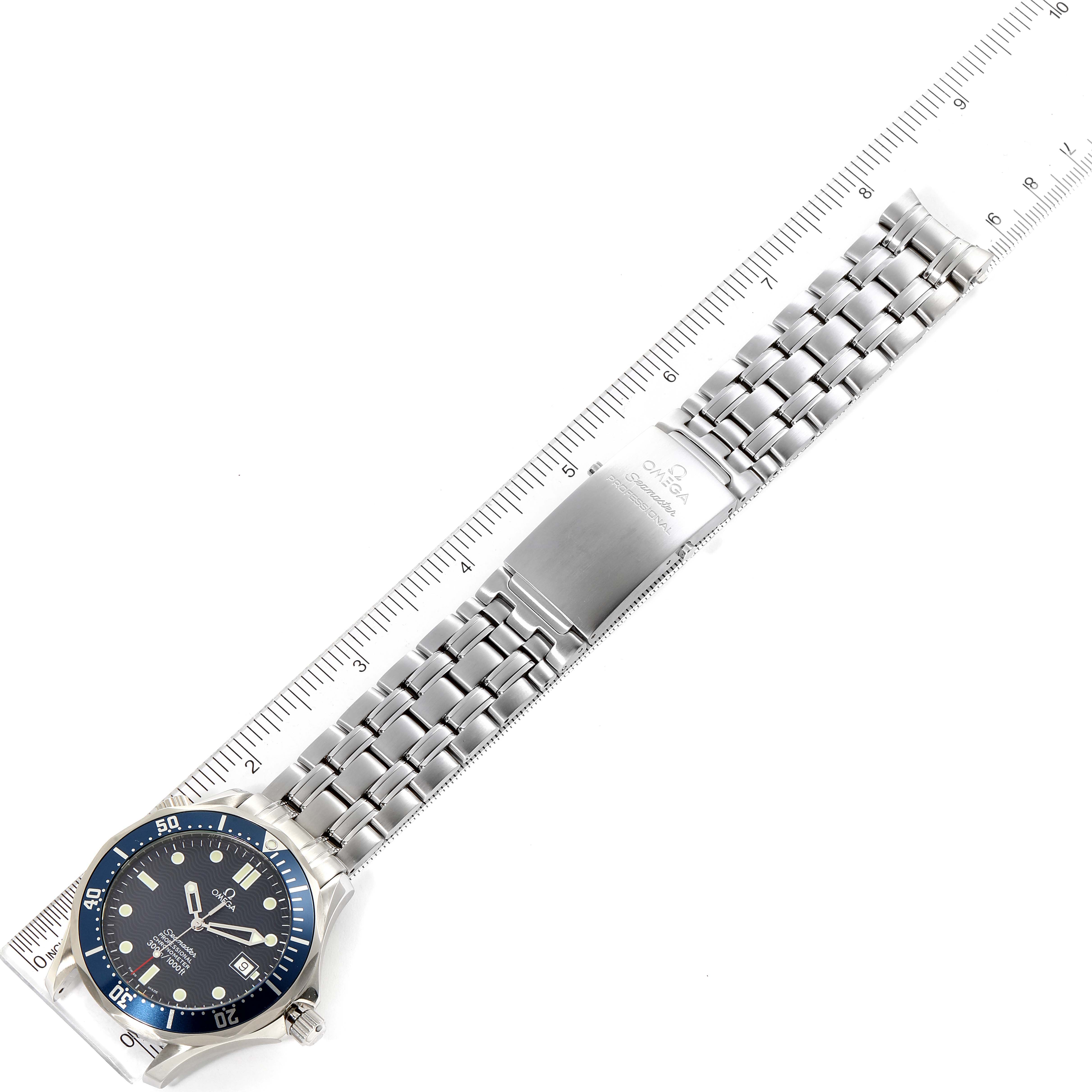 The image shows the Omega Seamaster 2531.80.00 Men
s Stainless Steel Blue Dial 2531.80.00 Men
s Stainless Steel Blue Dial watch laid flat with its metal bracelet and clasp, alongside a measuring ruler.