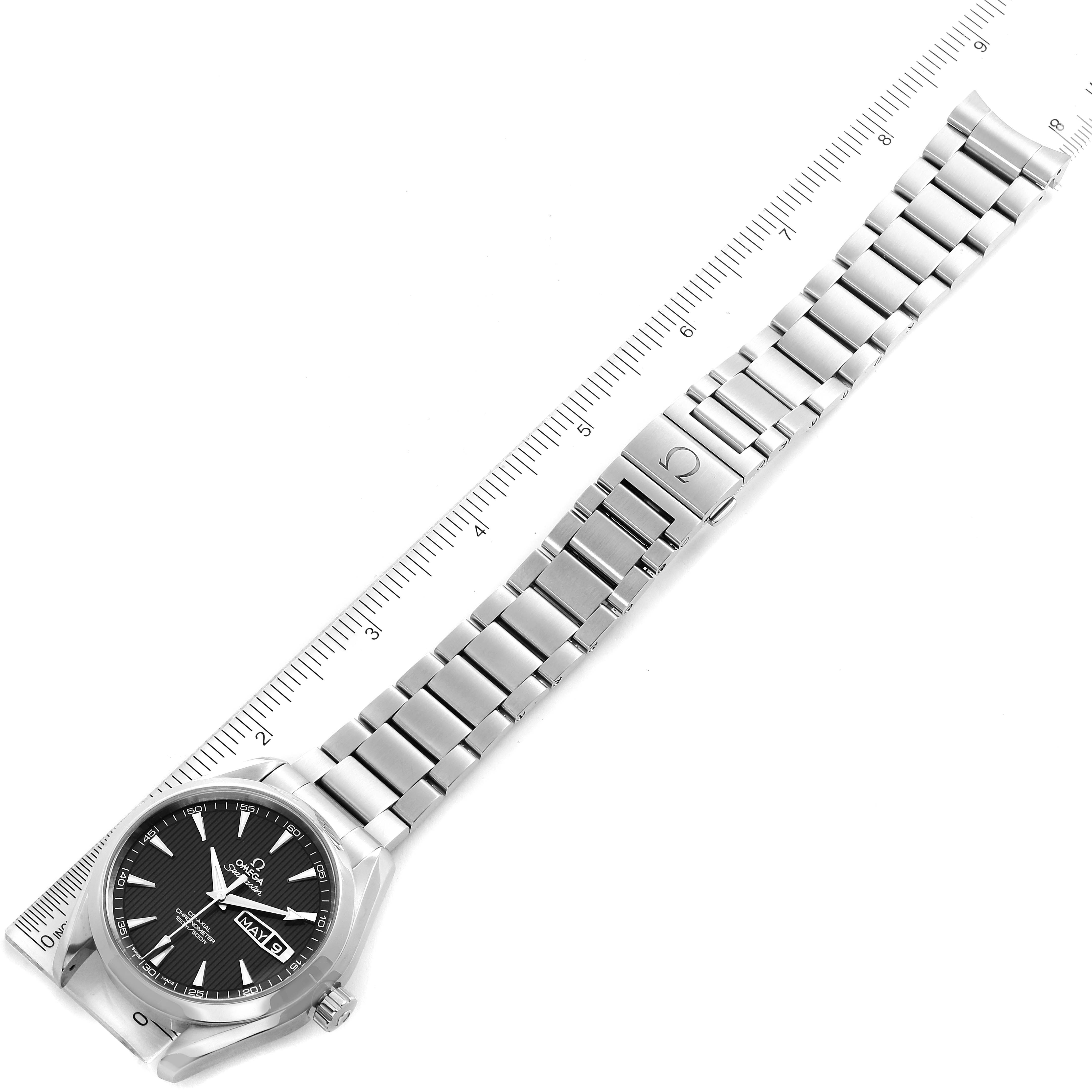 The image shows the Omega Aqua Terra 231.10.42.21.06.001 Men
s Stainless Steel Grey Dial 231.10.42.21.06.001 Men
s Stainless Steel Grey Dial watch from a top-down angle, displaying its face, bezel, and metal bracelet against a ruler for scale.