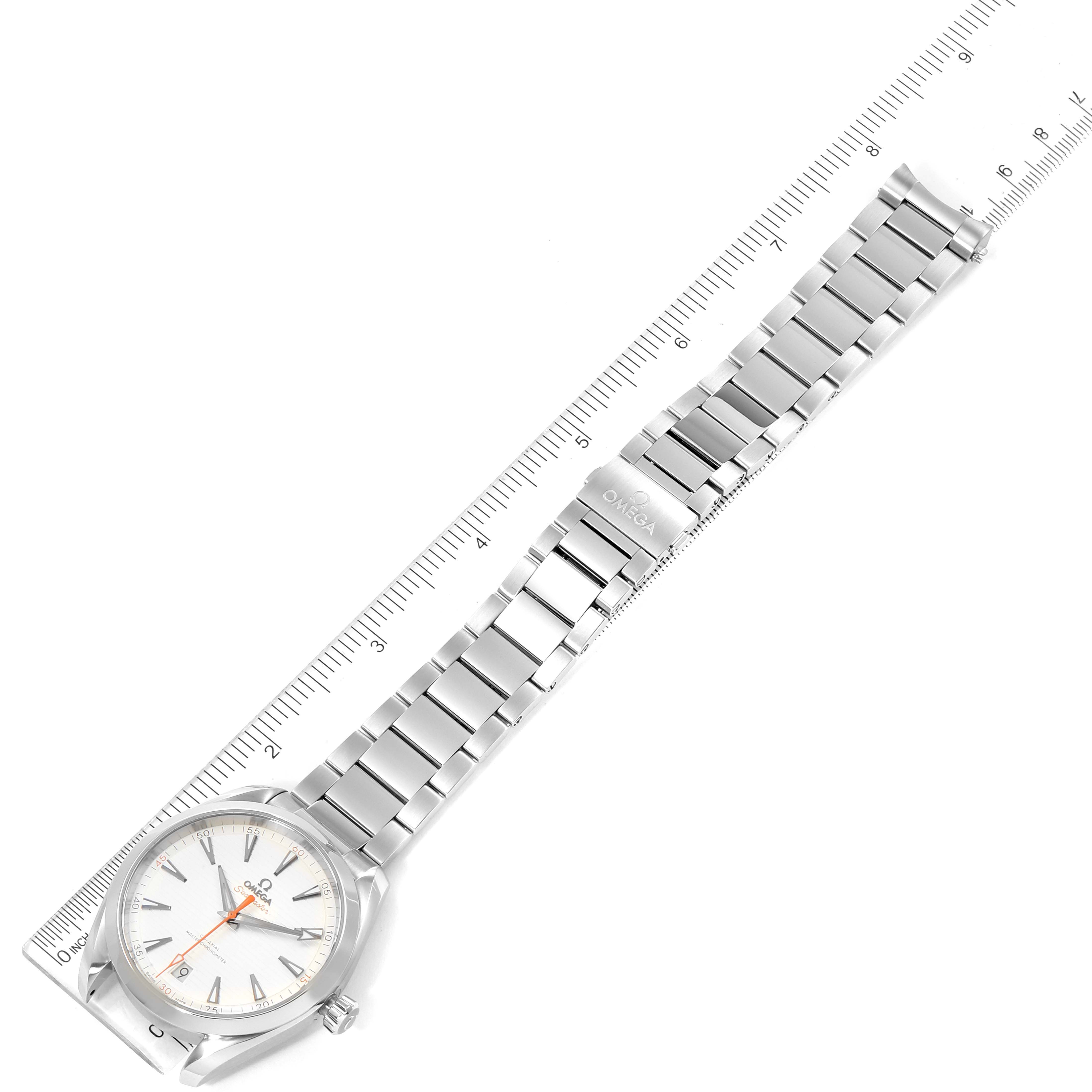 The image shows an overhead view of an Omega Aqua Terra 220.10.41.21.02.001 Men
s Stainless Steel Silver Dial 220.10.41.21.02.001 Men
s Stainless Steel Silver Dial watch laying alongside a ruler, highlighting the watch
s face and stainless steel bracelet.