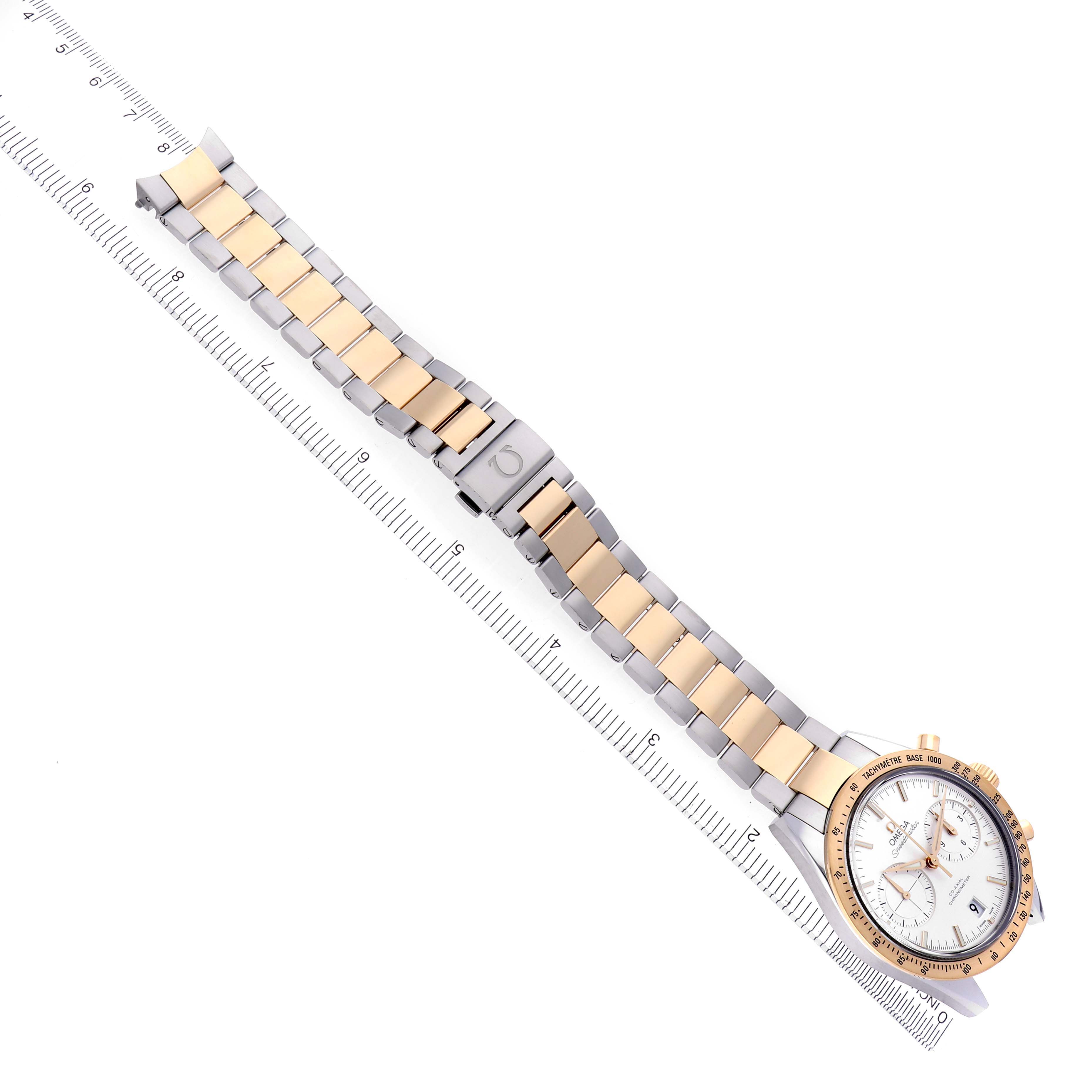 The image shows an Omega Speedmaster 331.20.42.51.02.001 Men
s Steel and Gold (two tone) Silver Dial 331.20.42.51.02.001 Men
s Steel and Gold (two tone) Silver Dial watch laid flat, highlighting its two-tone bracelet and face next to a ruler for scale.