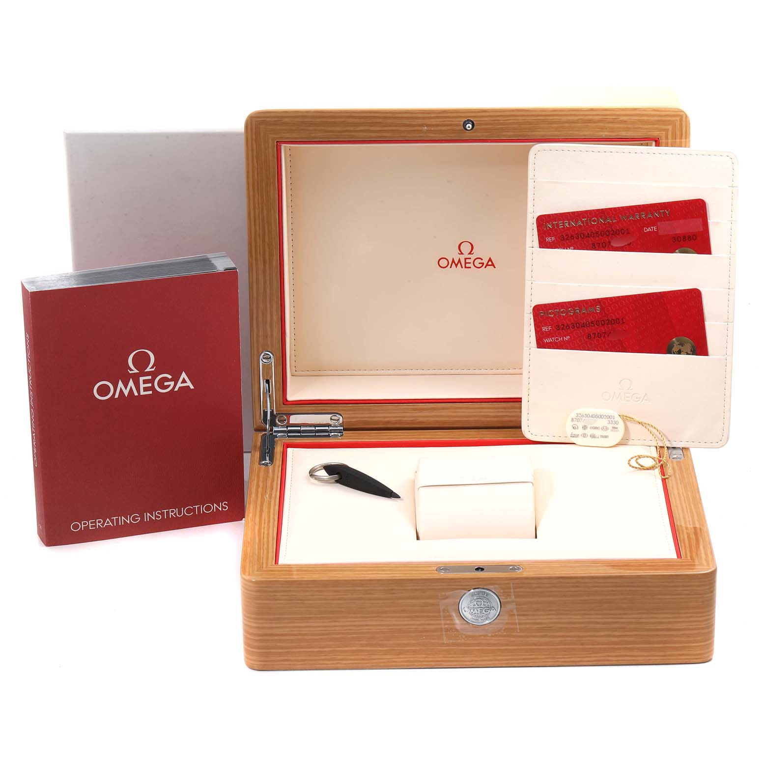 The image shows the opened box of an Omega Speedmaster 326.30.40.50.02.001 Men
s Stainless Steel Silver Dial 326.30.40.50.02.001 Men
s Stainless Steel Silver Dial, along with its operating instructions and warranty cards.