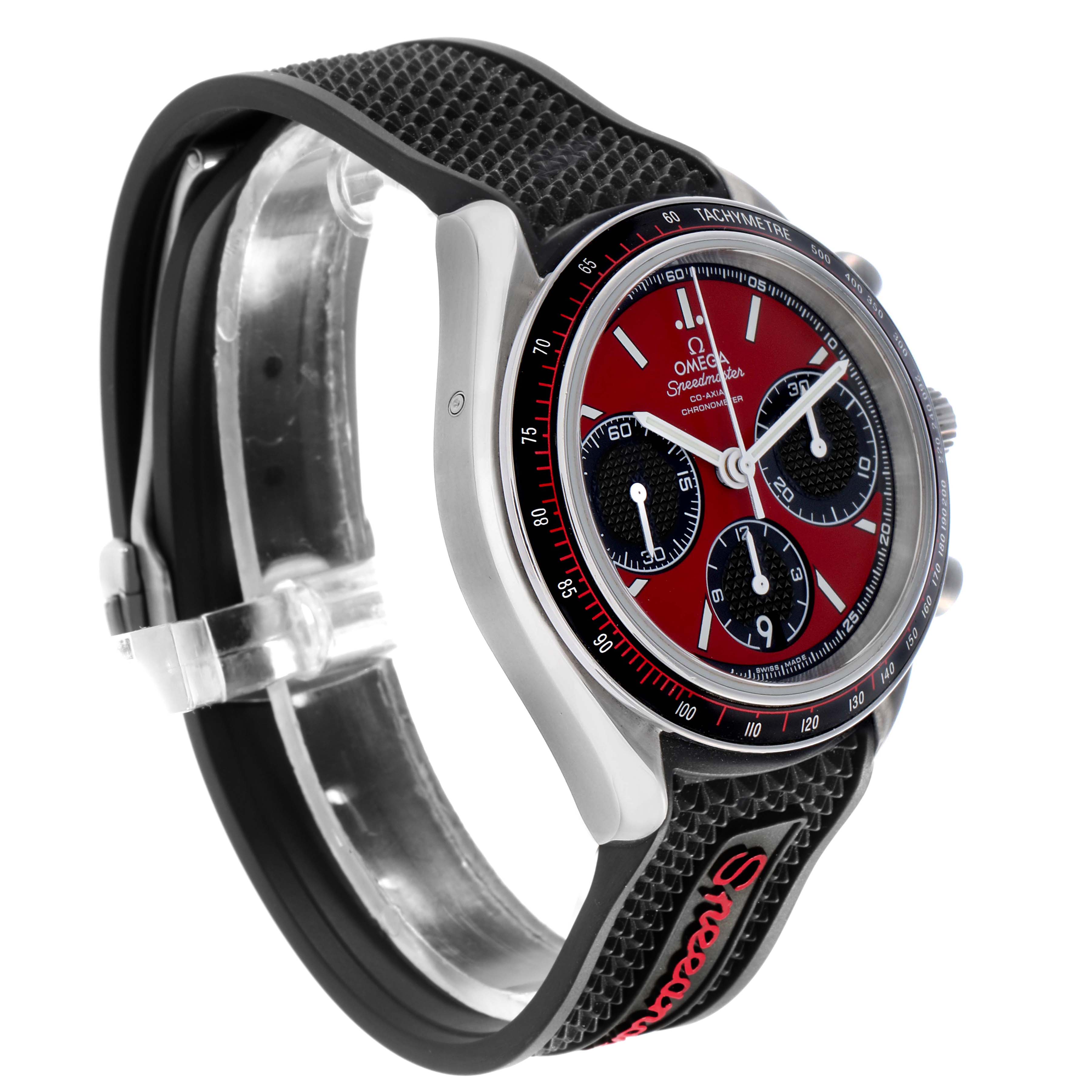 The Omega Speedmaster 326.32.40.50.11.001 Men's Stainless Steel Red Dial watch is shown at an angled side view, highlighting the red dial, chronograph subdials, and textured strap.