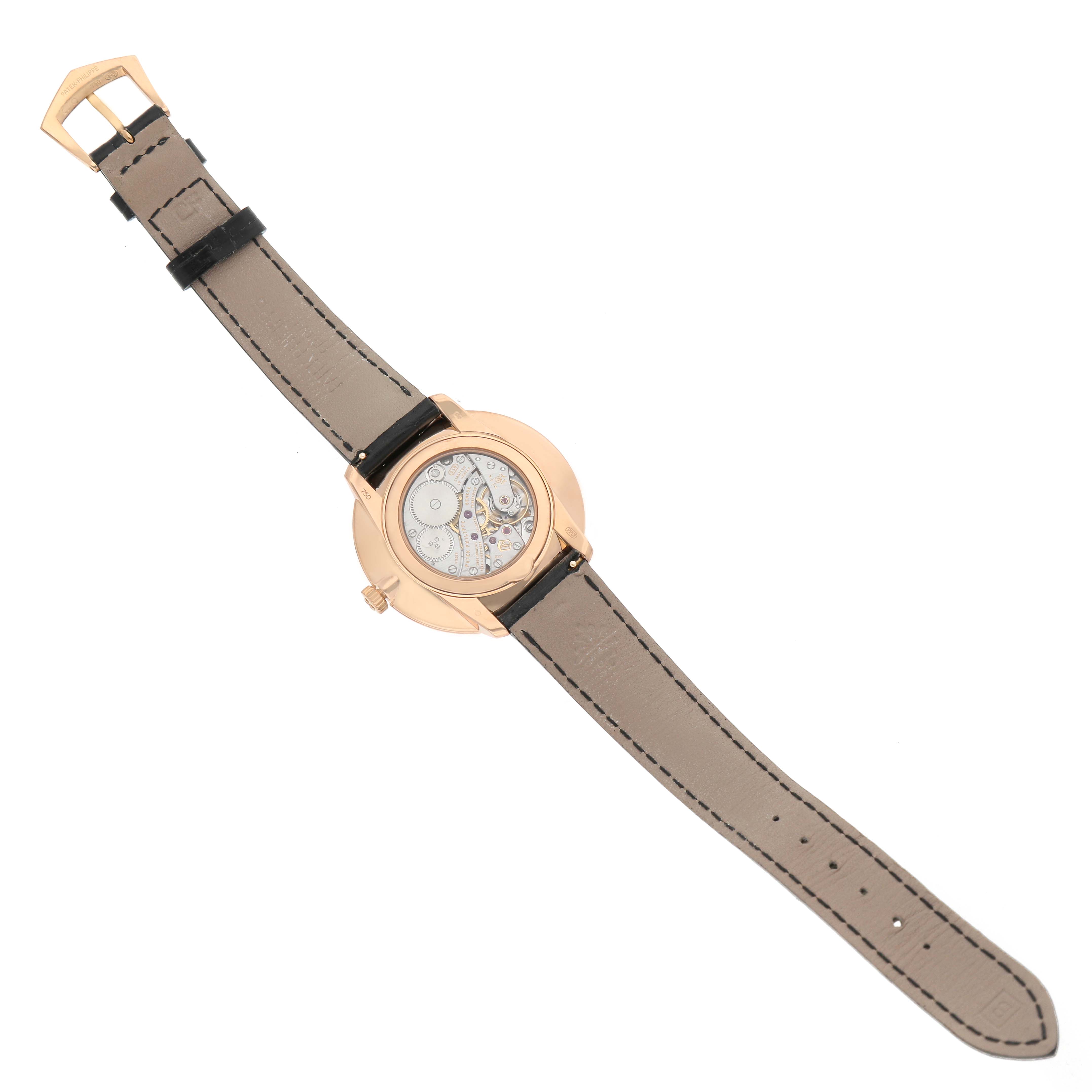 The Patek Philippe Calatrava 5123R Men's Rose Gold Silver Dial watch is shown from the back, displaying the movement and leather strap.