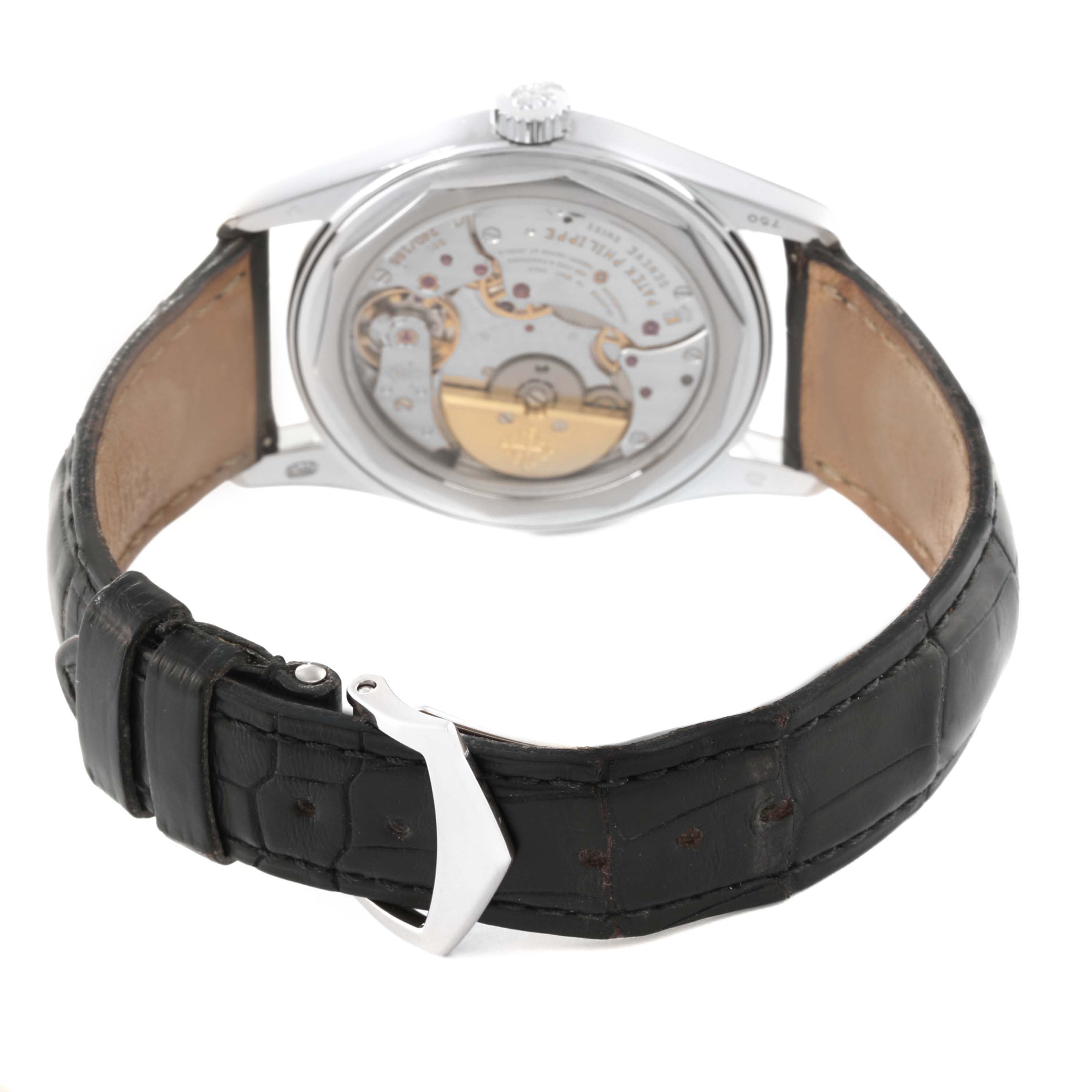 The image shows the back view of a Patek Philippe Calatrava 6000G-012 Men's White Gold Blue Dial 6000G-012 Men's White Gold Blue Dial watch, highlighting its movement and leather strap.