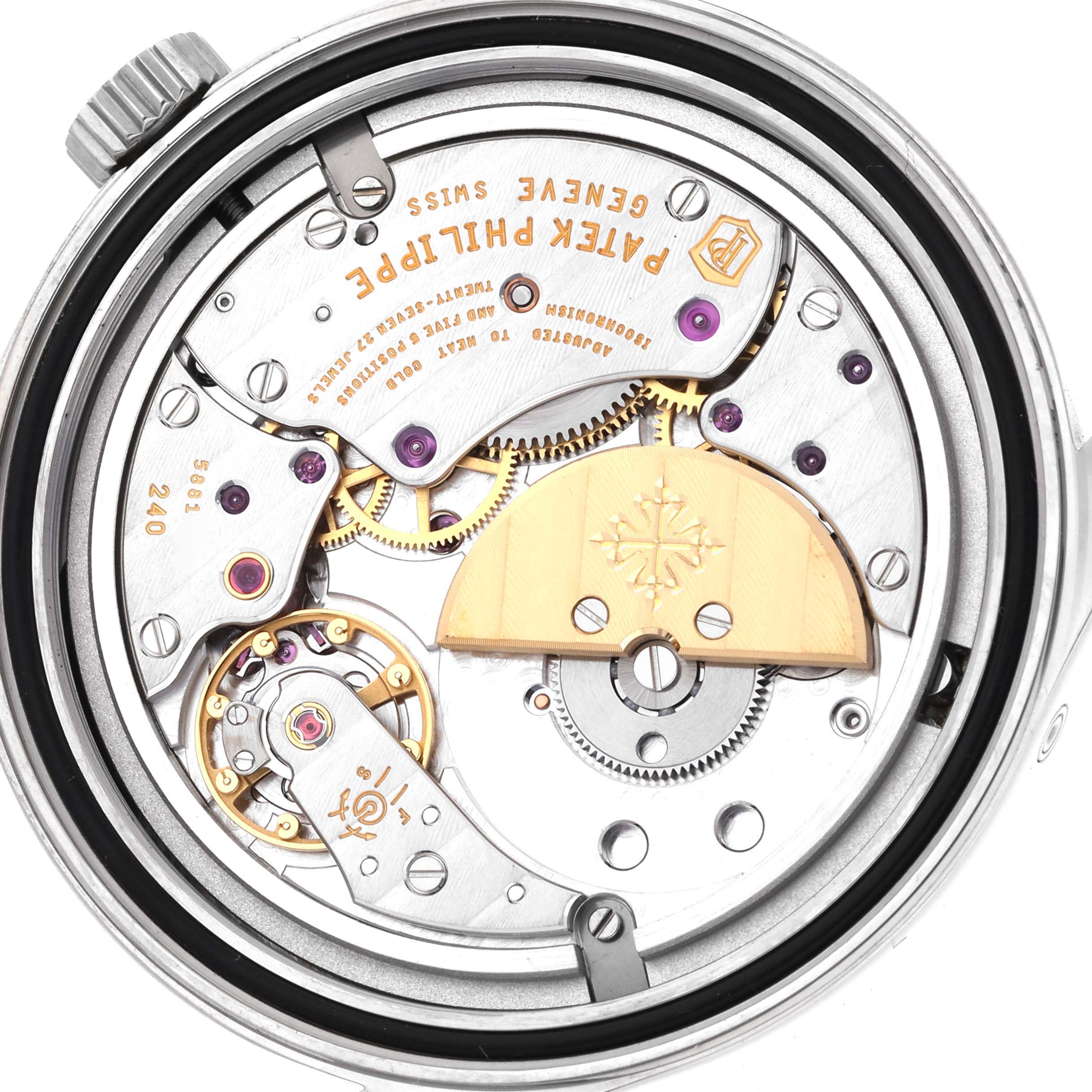 The image shows the movement mechanism of the Patek Philippe Calatrava 6000G-012 Men's White Gold Blue Dial 6000G-012 Men's White Gold Blue Dial watch, viewed from the back with visible gears and inscriptions.