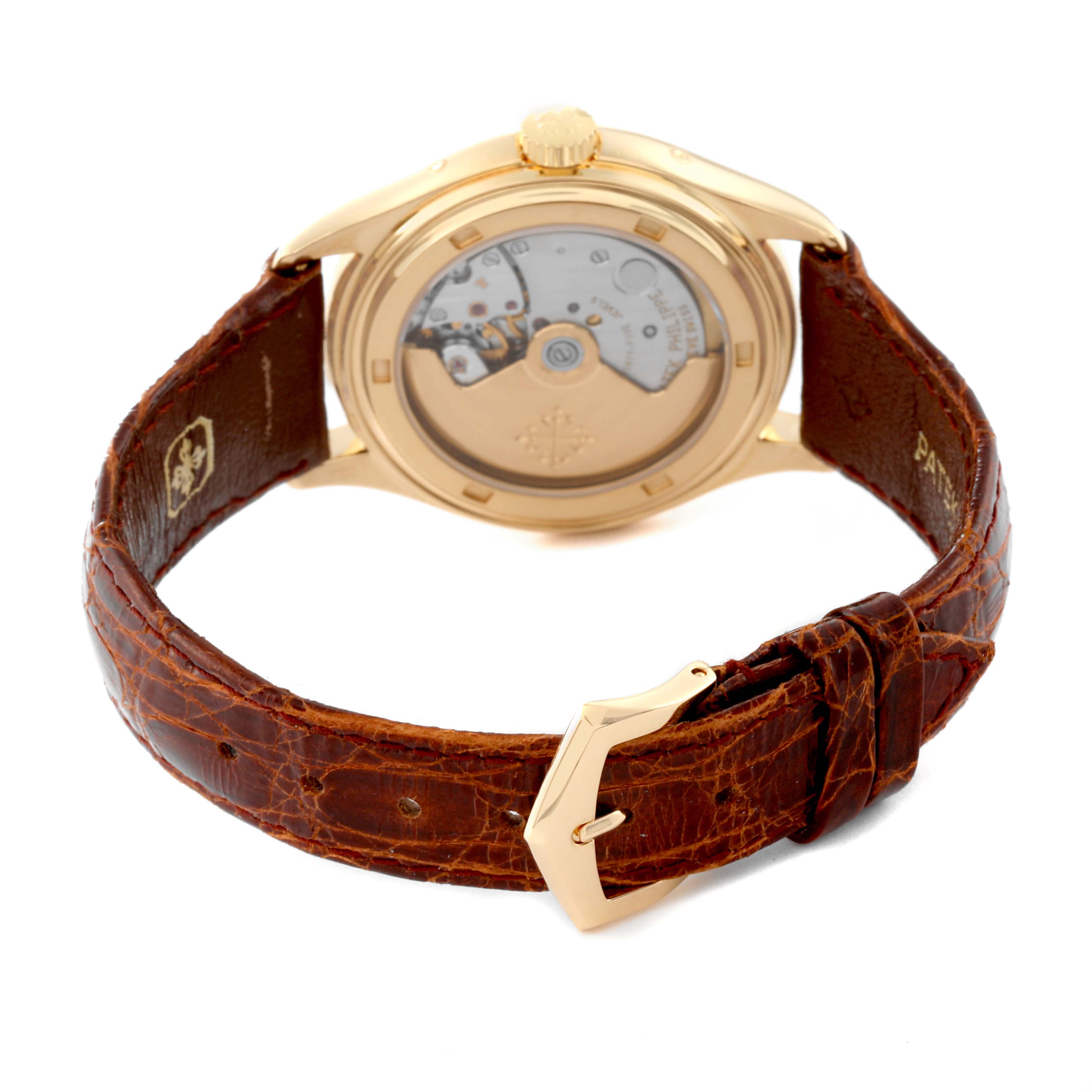 This image shows the back view of a Patek Philippe Complications 5035J-001 Men
s Yellow Gold Silver Dial 5035J-001 Men
s Yellow Gold Silver Dial watch, showcasing its movement through the transparent case back and its brown leather strap.