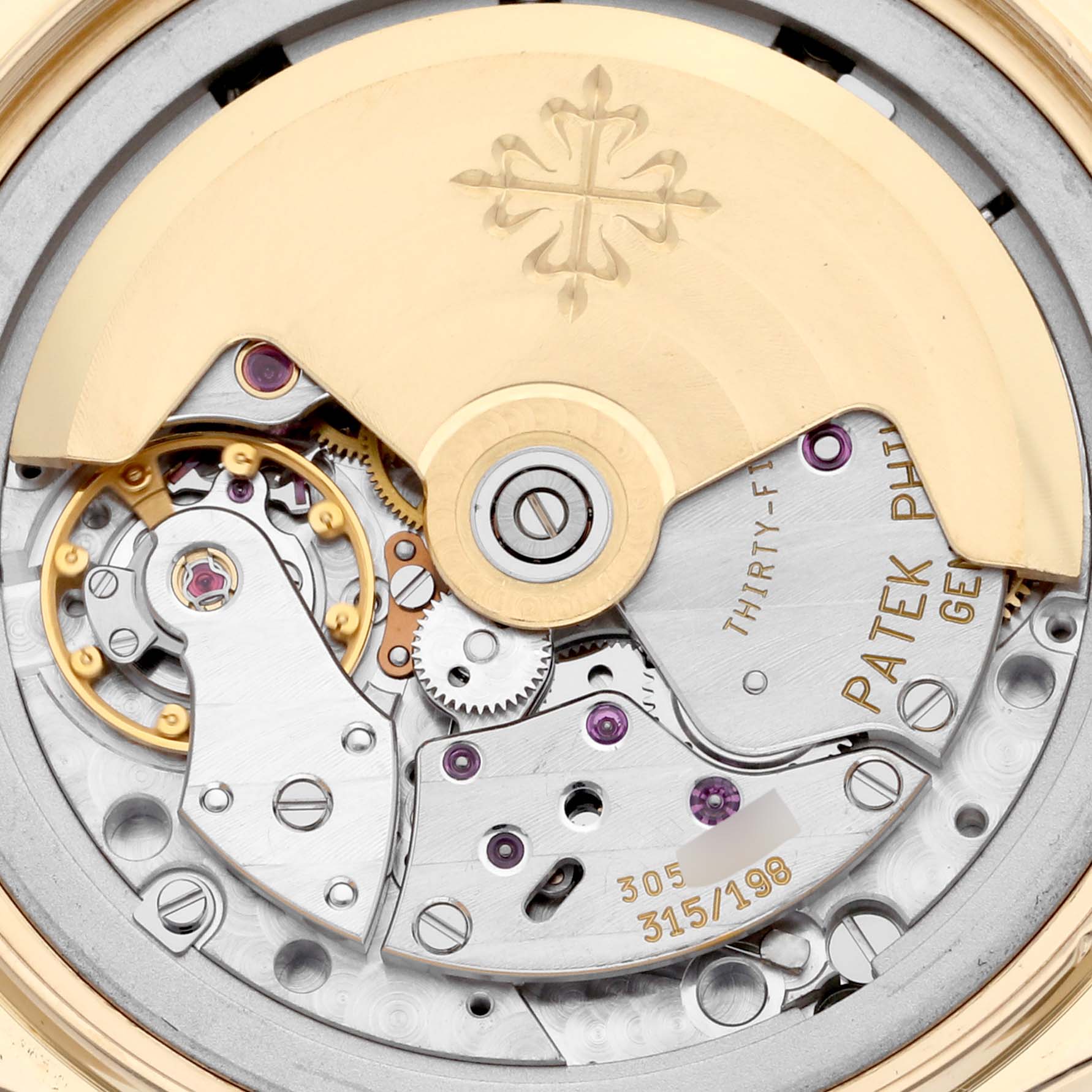 The image shows the intricate mechanical movement of the Patek Philippe Complications 5035J-001 Men
s Yellow Gold Silver Dial 5035J-001 Men
s Yellow Gold Silver Dial model.