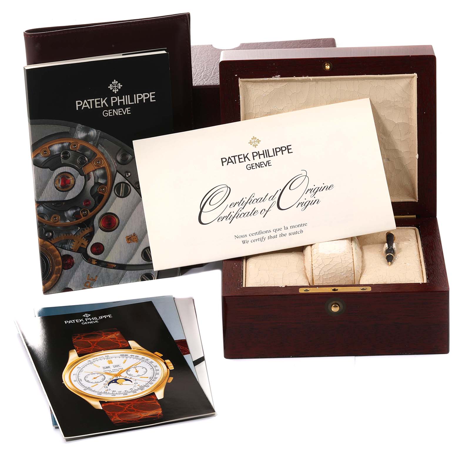 The image shows the box, certificate of origin, and booklet for the Patek Philippe Complications 5035J-001 Men
s Yellow Gold Silver Dial 5035J-001 Men
s Yellow Gold Silver Dial model watch.
