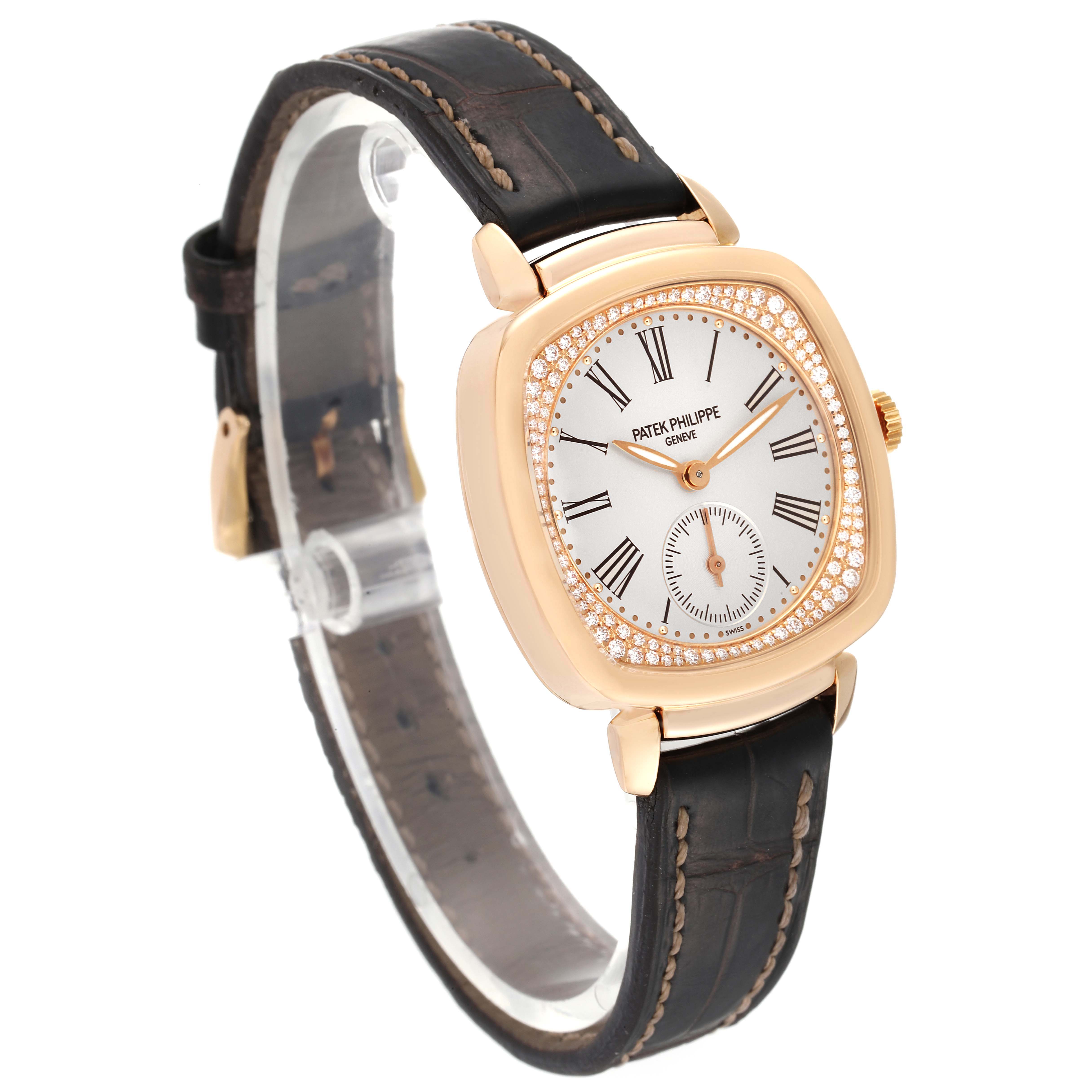 The image shows a Patek Philippe Gondolo 7041R-001 Women
s Rose Gold Silver Dial 7041R-001 Women
s Rose Gold Silver Dial watch at an angled view, highlighting its face, bezel, leather strap, and clasp.