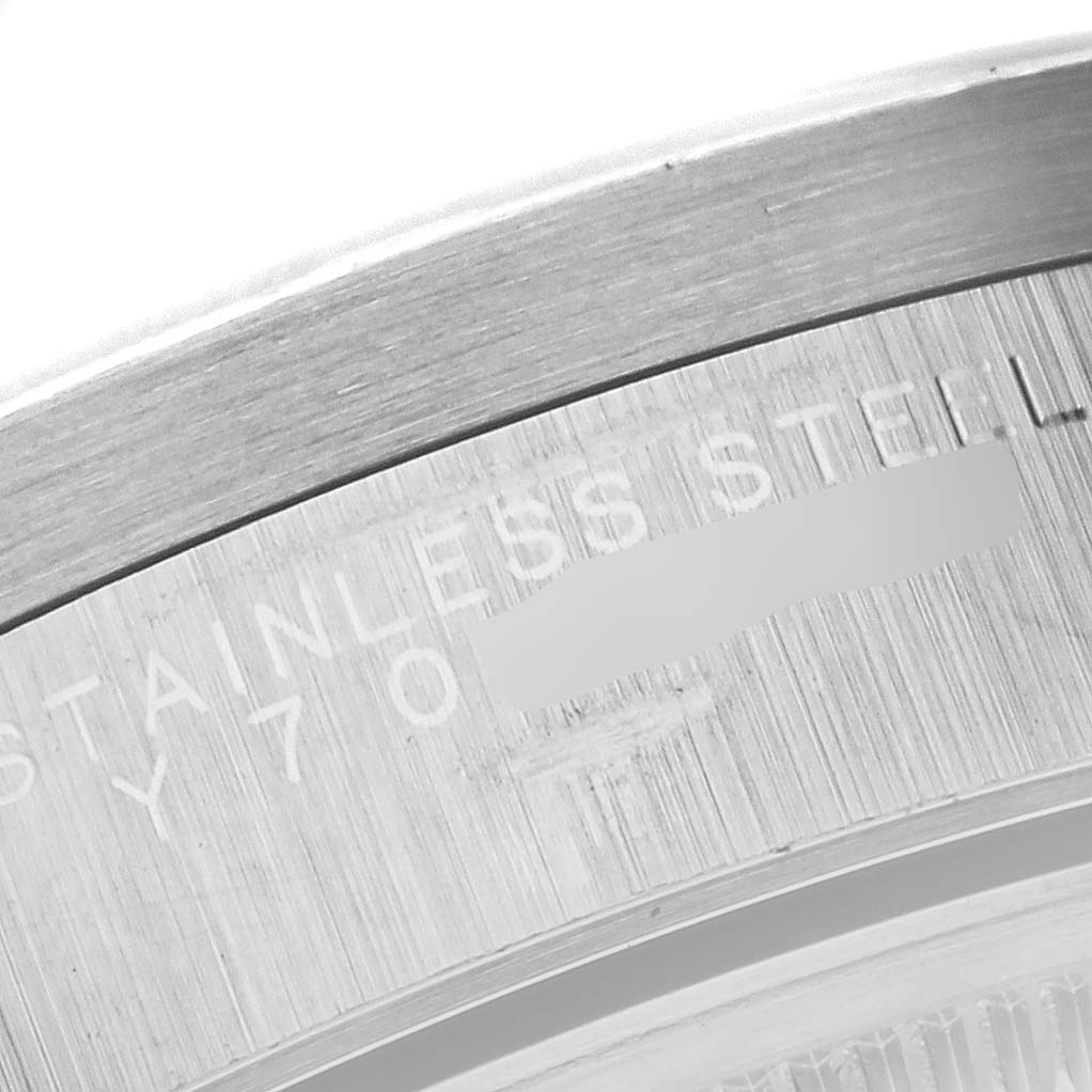 The image shows a close-up of the backside of a Rolex Air-King 14010 Men's Stainless Steel Black Dial 14010 Men's Stainless Steel Black Dial watch, focusing on the stainless steel case and the etched text.