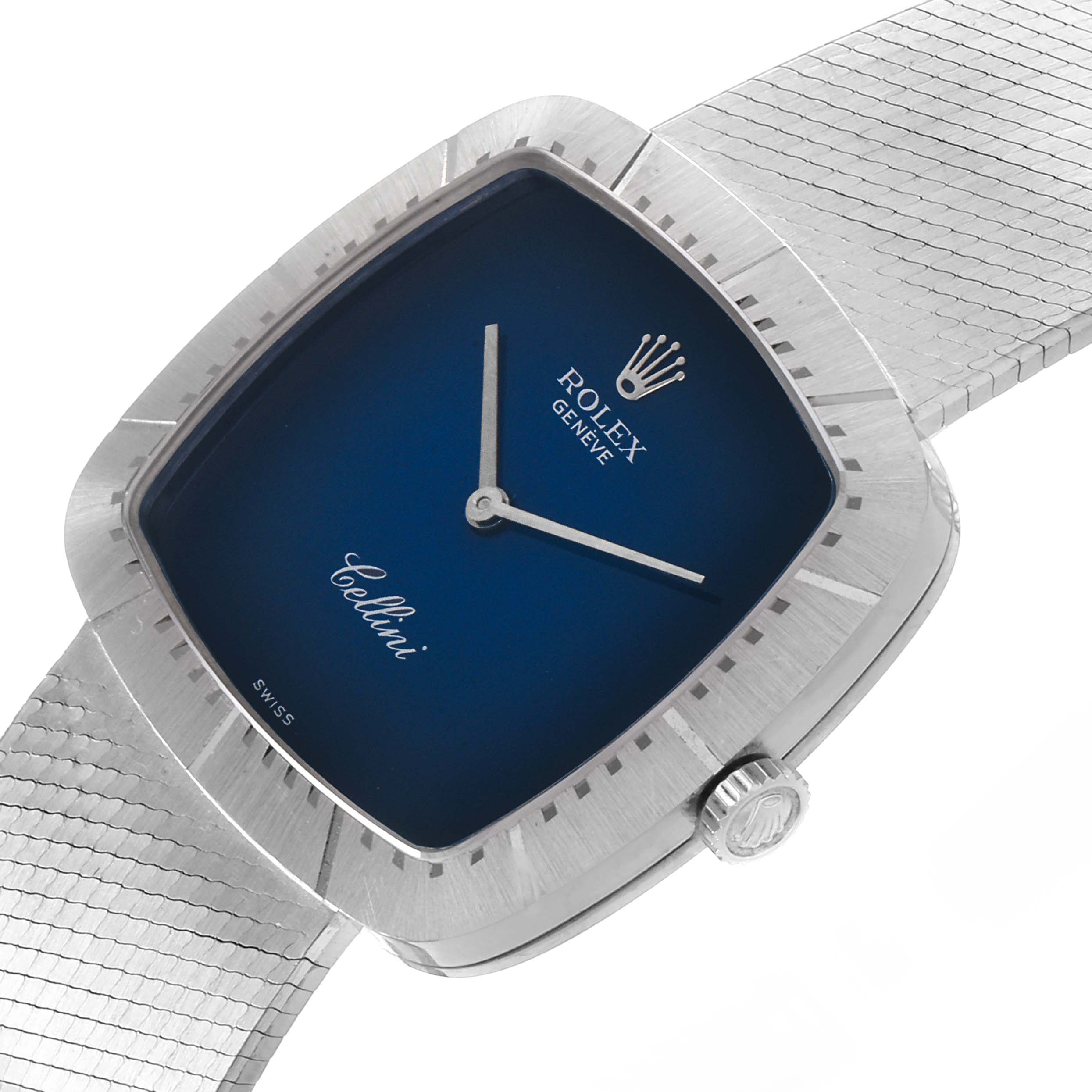 The image shows a close-up angled view of a Rolex Cellini 4320 Men
s White Gold White Dial 4320 Men
s White Gold White Dial watch, highlighting its blue dial, silver case, and crown.