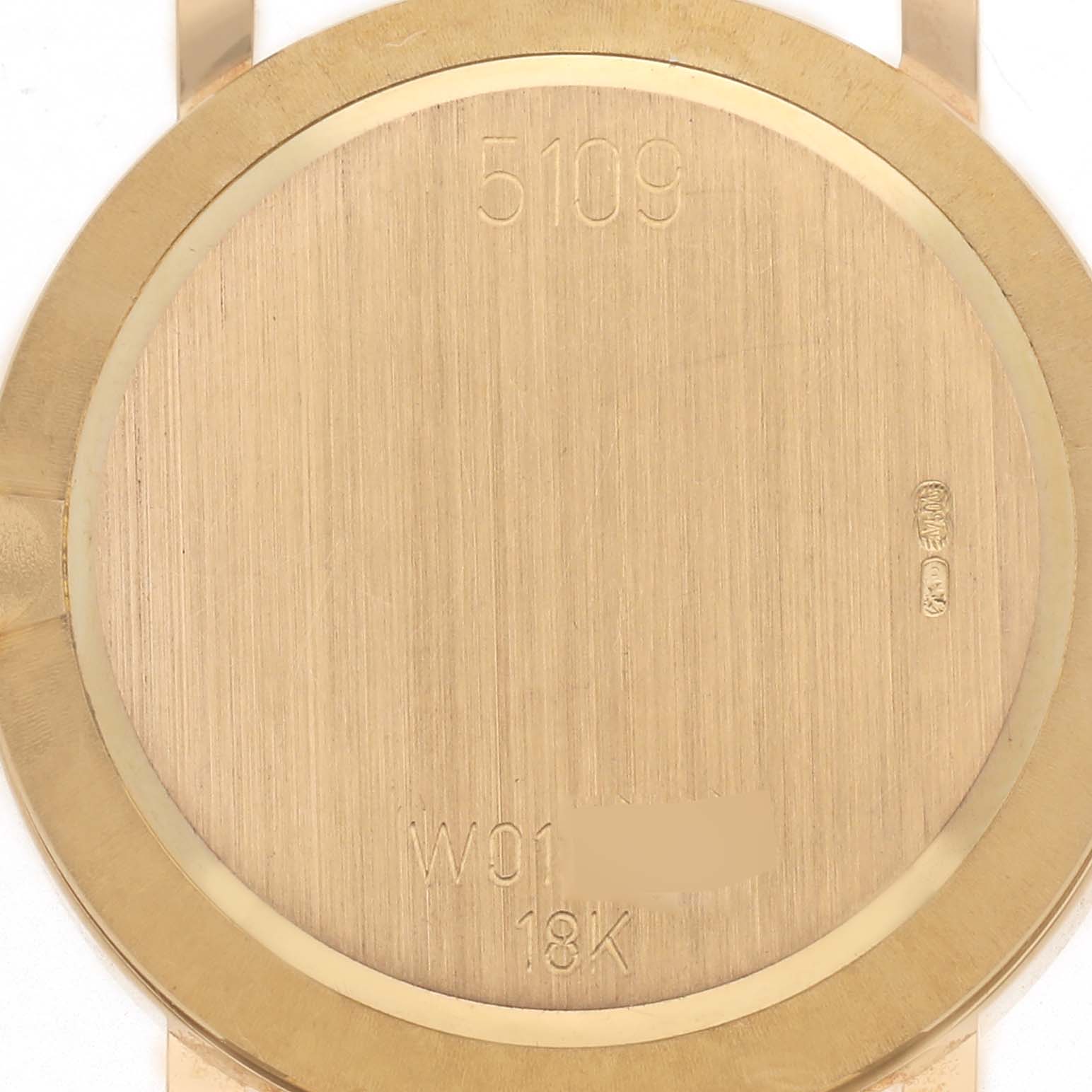 The image shows the back case of a Rolex Cellini 5109 Women
s Yellow Gold Mother of Pearl Dial 5109 Women
s Yellow Gold Mother of Pearl Dial watch, featuring engravings and a brushed finish.