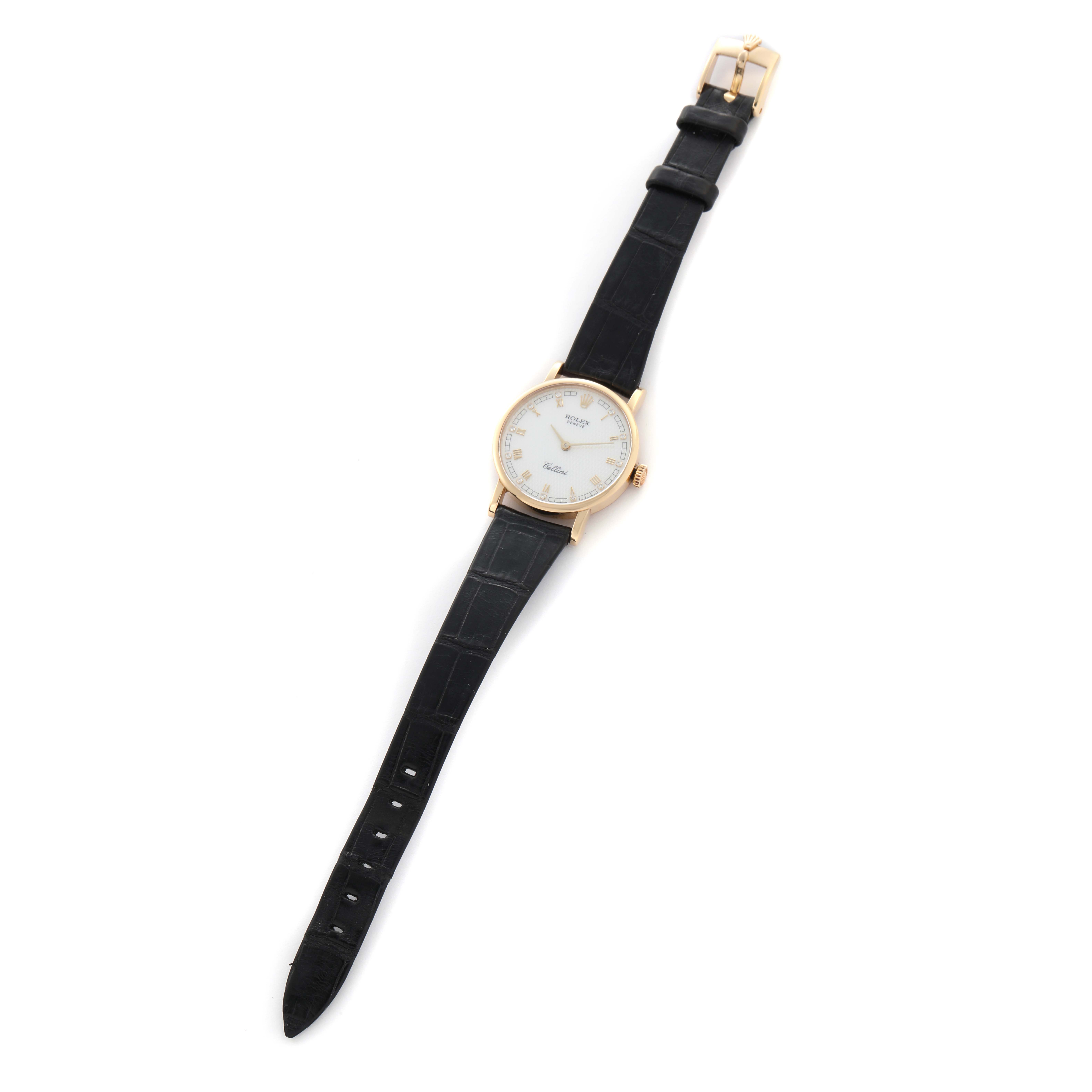 The Rolex Cellini 5109 Women
s Yellow Gold Mother of Pearl Dial 5109 Women
s Yellow Gold Mother of Pearl Dial watch is shown from a top-down angle, displaying its face, black strap, and gold buckle.