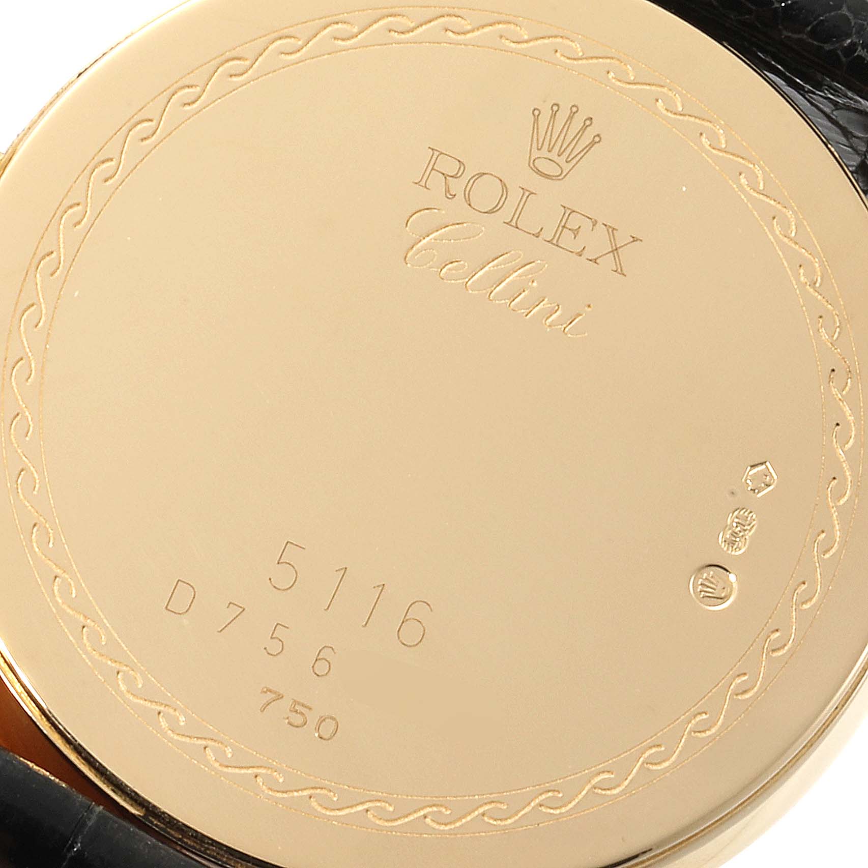 This image shows the back case of a Rolex Cellini 5116 Men's Yellow Gold Black Dial 5116 Men's Yellow Gold Black Dial watch, displaying its engravings and hallmarks.
