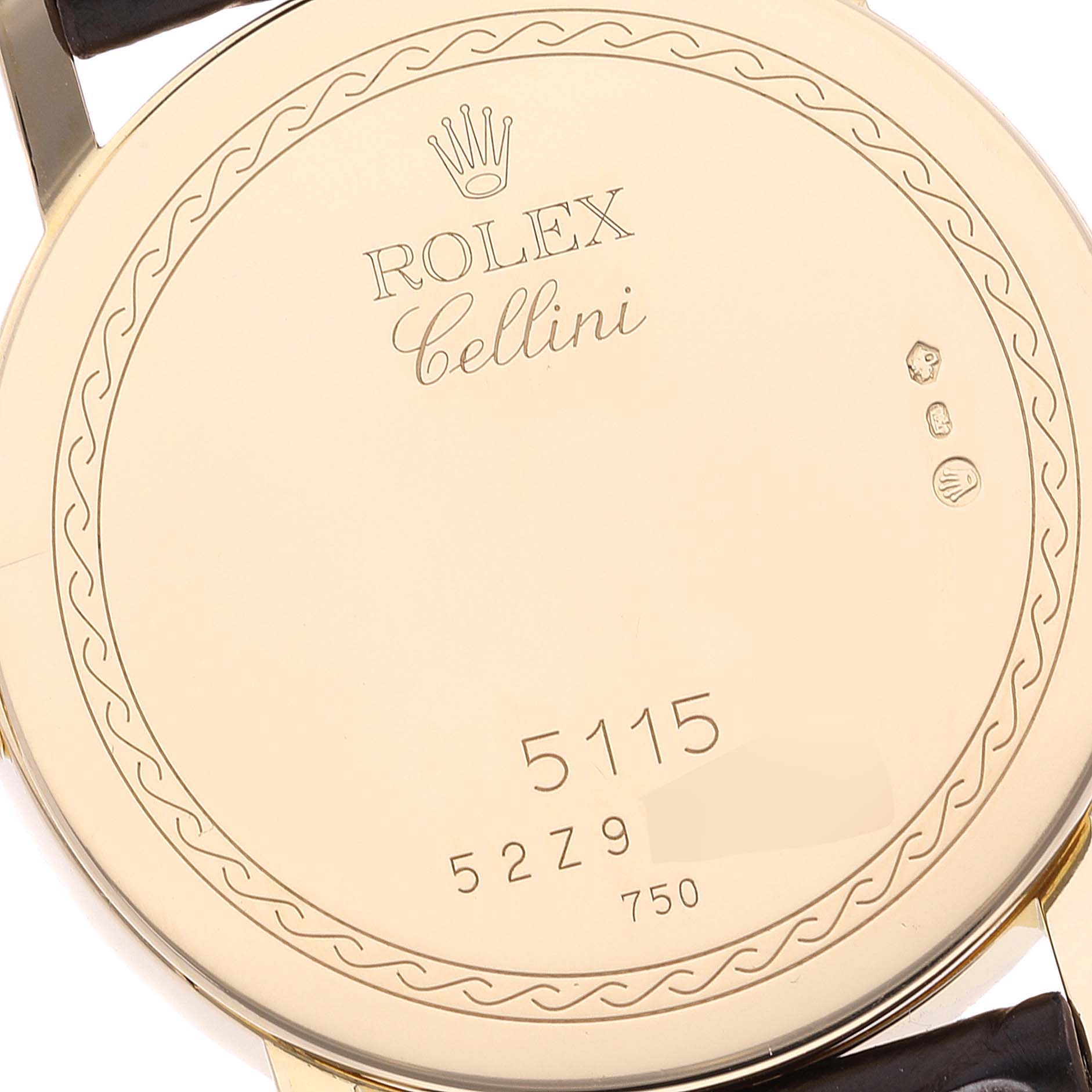 This image shows the back case of a Rolex Cellini 5115 Men's Yellow Gold Champagne Dial 5115 Men's Yellow Gold Champagne Dial model watch, displaying engraved details and serial numbers.