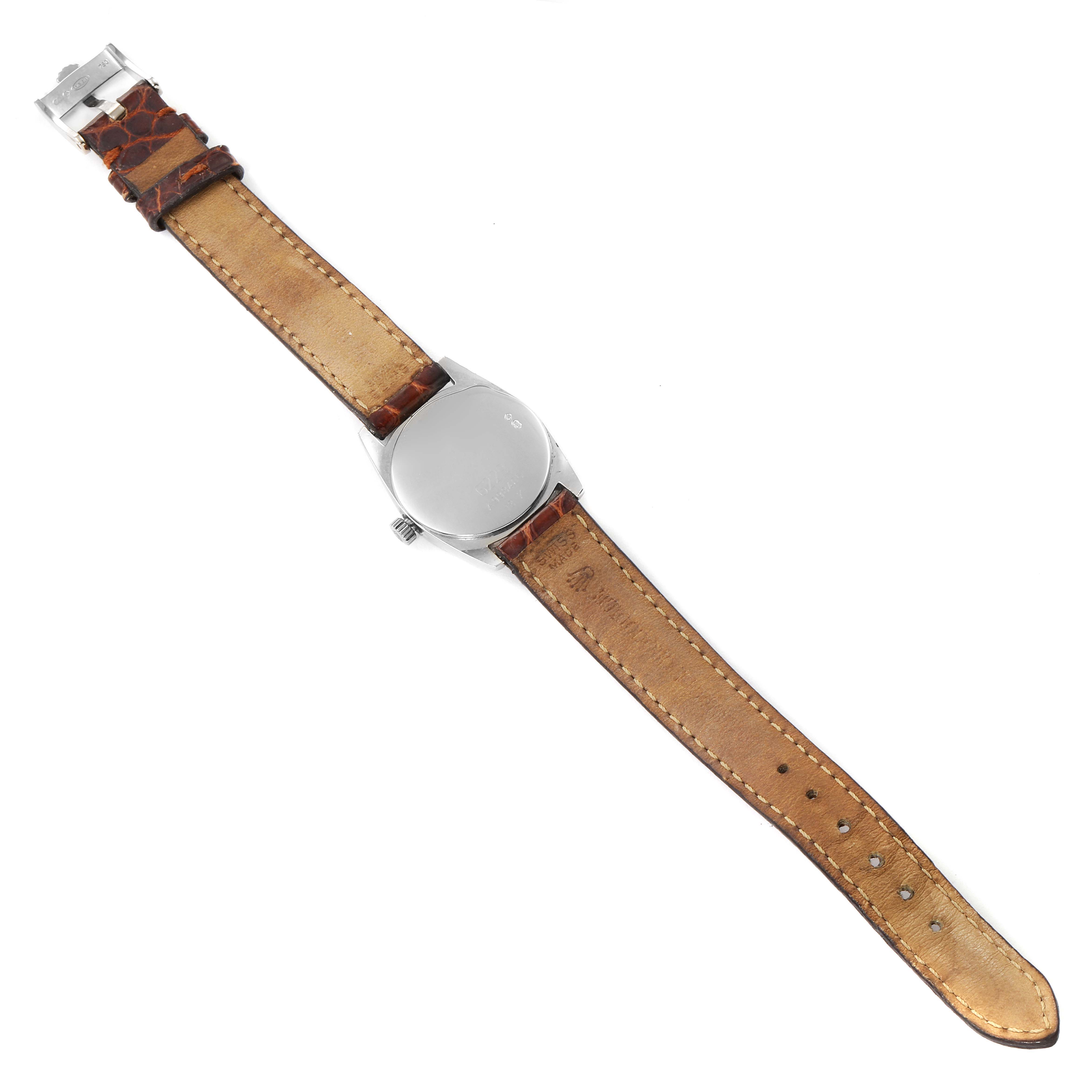 The Rolex Cellini 6229 Women's White Gold White Dial 6229 Women's White Gold White Dial watch is shown in a top-down view, displaying its back case and leather strap.