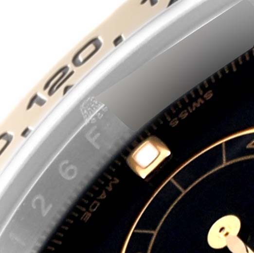 The image shows a close-up of the bezel and partial dial of a Rolex Daytona 116503 Men's Steel and Gold (two tone) Black Dial 116503 Men's Steel and Gold (two tone) Black Dial watch.