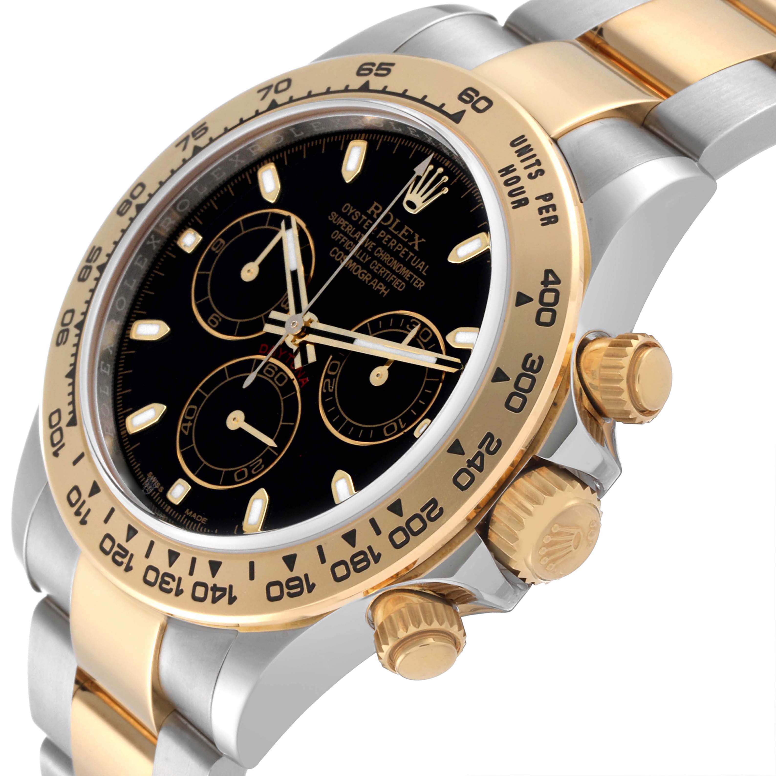 The image shows a close-up angled view of the Rolex Daytona 116503 Men's Steel and Gold (two tone) Black Dial 116503 Men's Steel and Gold (two tone) Black Dial watch, highlighting its dial, bezel, and crown.