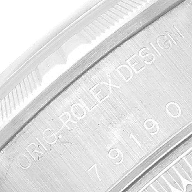 This close-up image shows the serial number on the side of the bezel of a Rolex Datejust 79190 Women's Stainless Steel Blue Dial 79190 Women's Stainless Steel Blue Dial model.