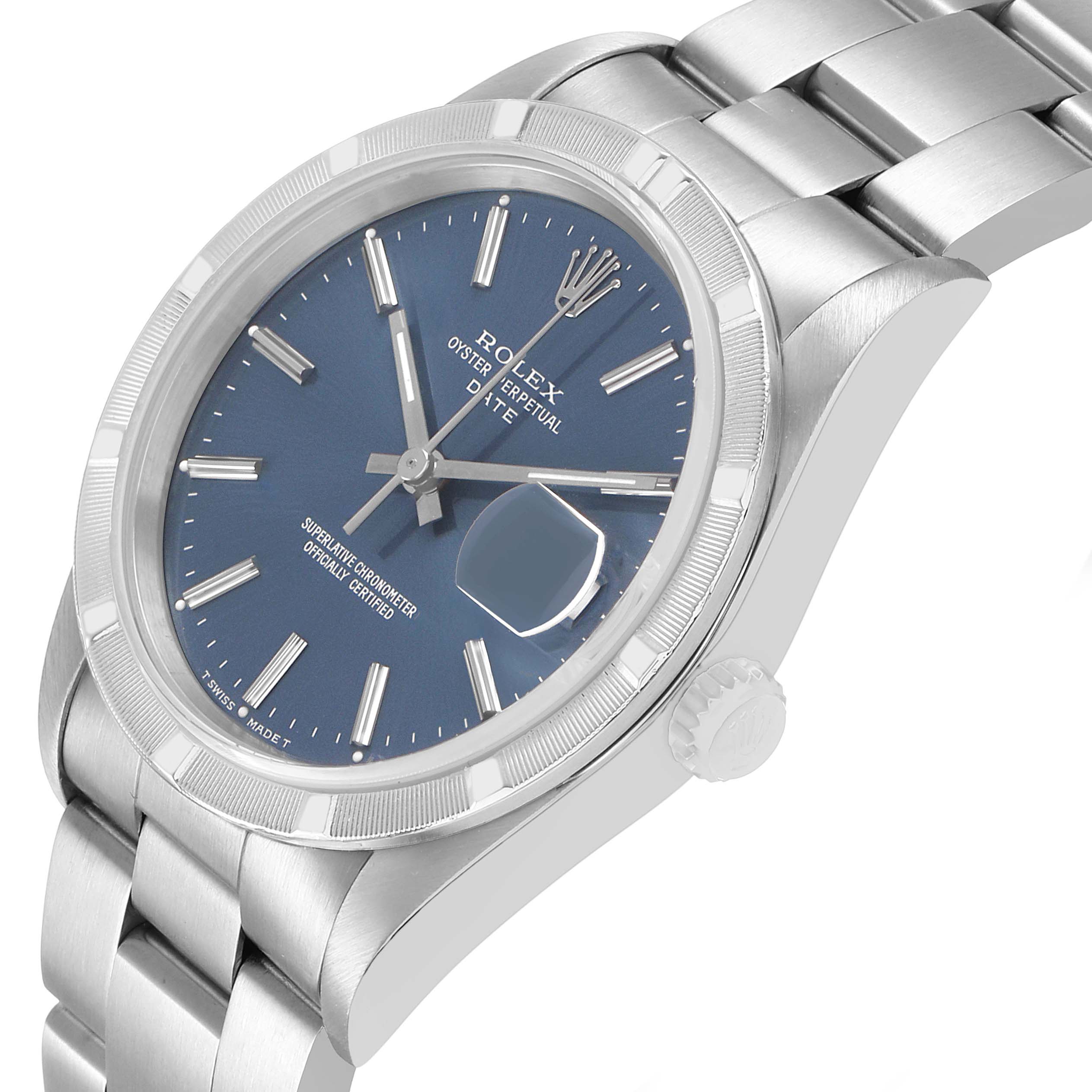 The image shows a Rolex Date 15210 Men's Stainless Steel Blue Dial watch at an angled view, highlighting the blue dial, fluted bezel, and bracelet.