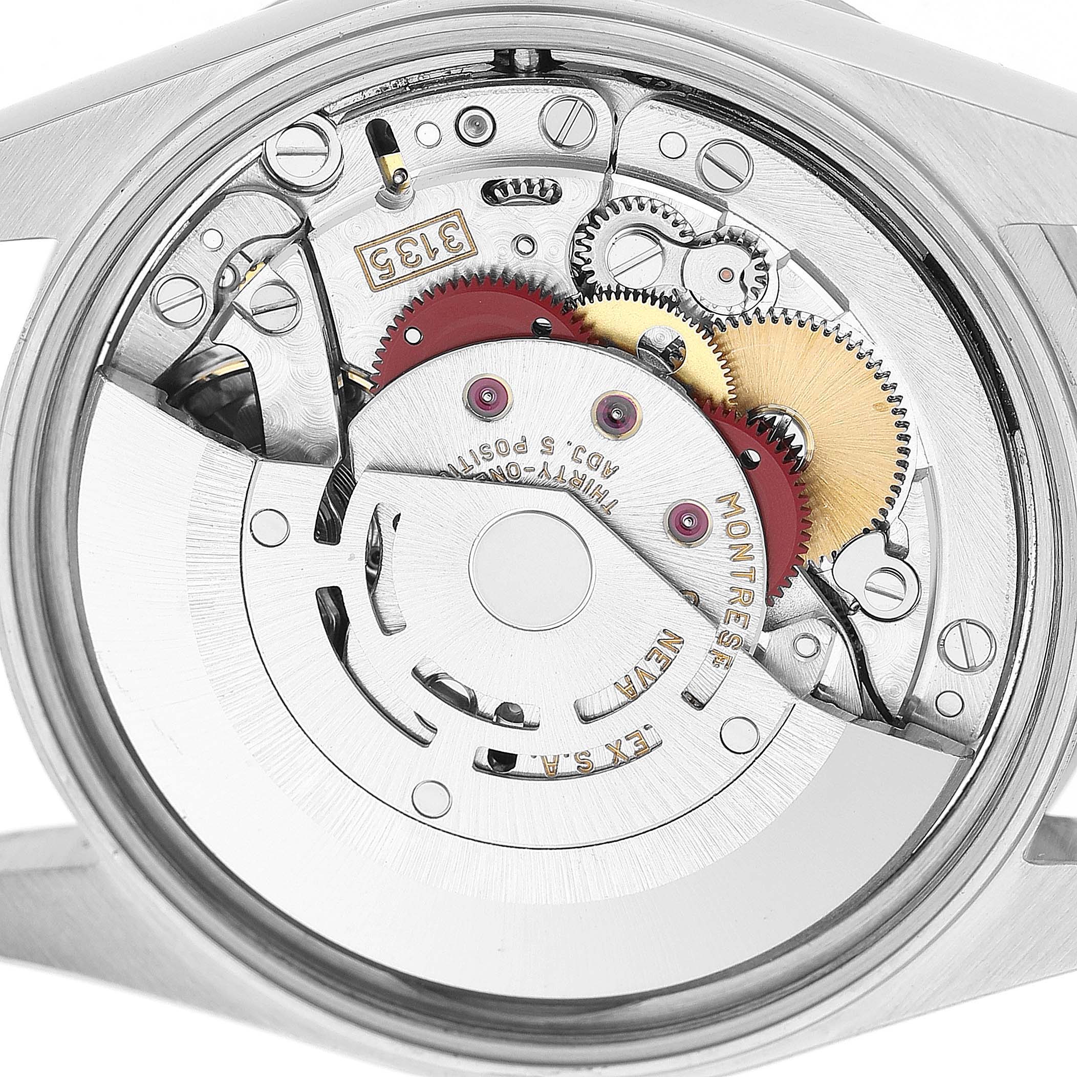 The image shows the movement of a Rolex Date 15210 Men's Stainless Steel Blue Dial watch, highlighting gears and internal components from a back angle.