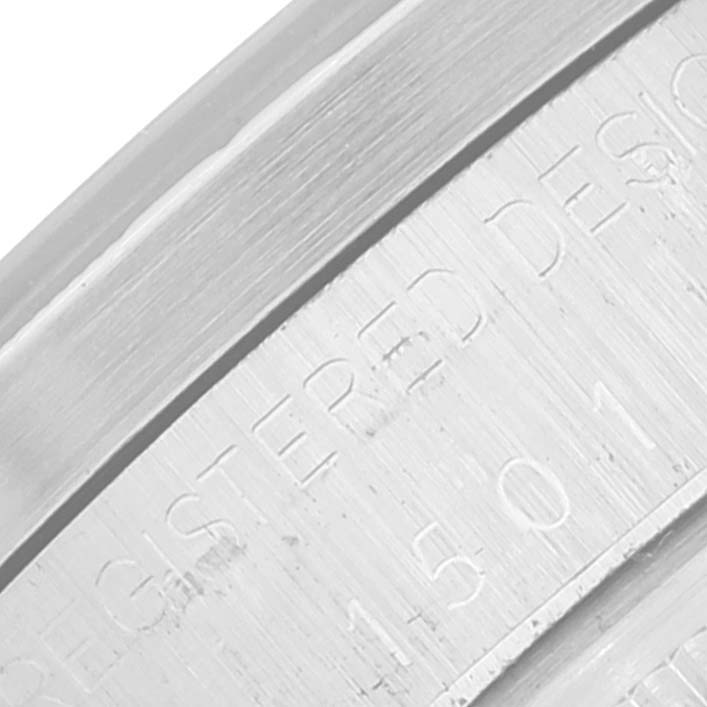 This image shows an extreme close-up of the edge and engraved writing on the case back of a Rolex Vintage Collection 1501 Men's Stainless Steel Silver Dial 1501 Men's Stainless Steel Silver Dial watch.