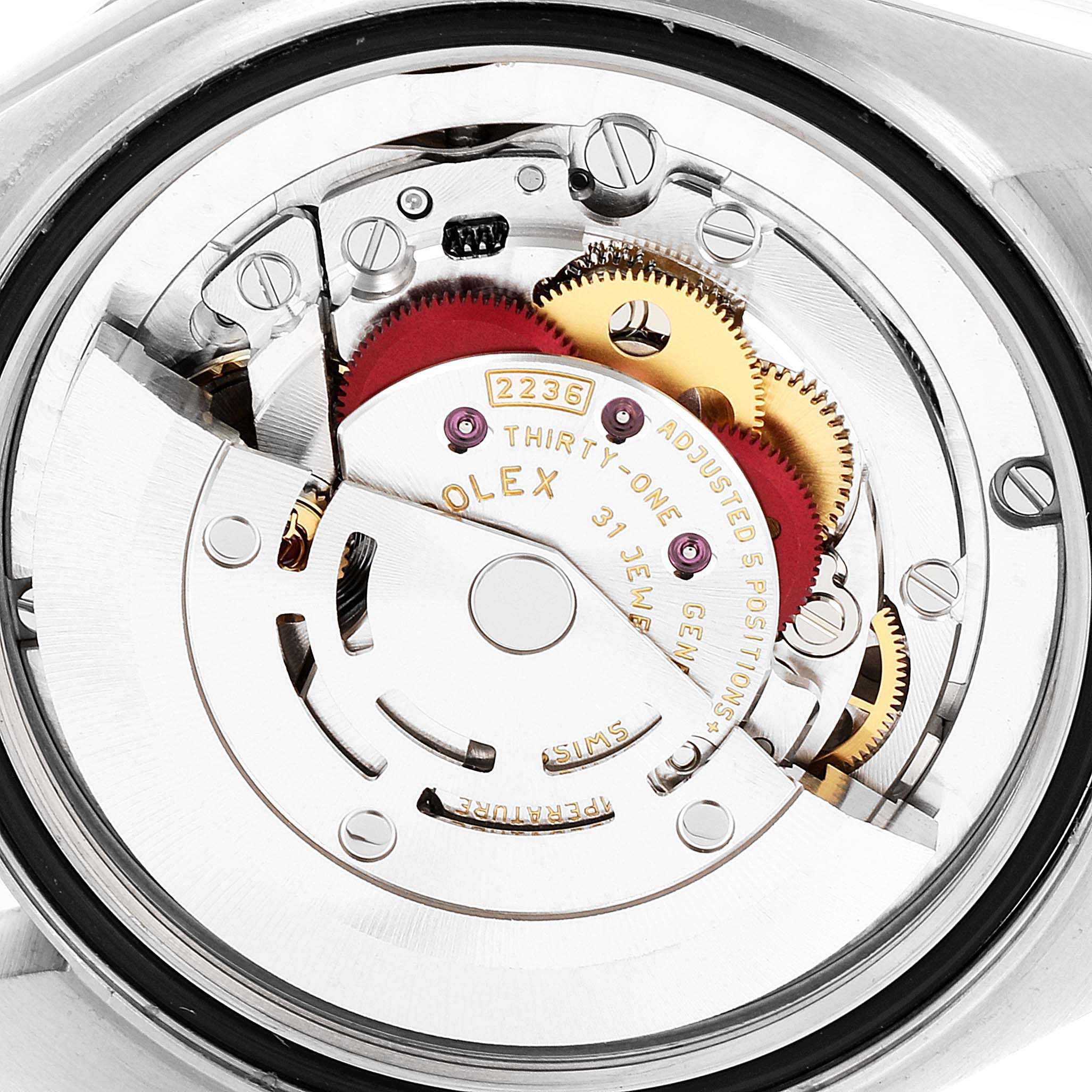 This image shows the movement mechanism of a Mid-Size Rolex watch from a close-up, angled view from the back.
