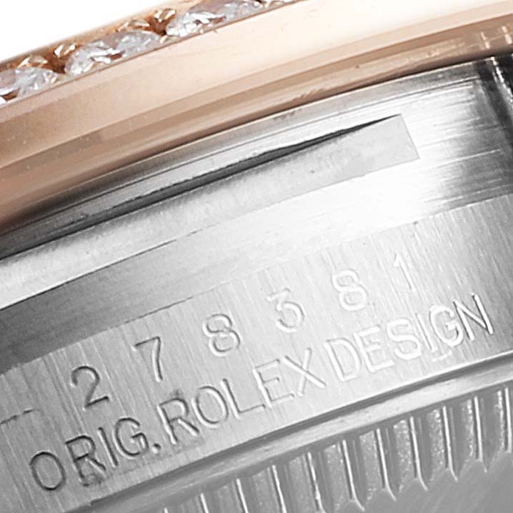 This close-up image shows the side view of a Mid-Size Rolex watch with engraving and a diamond-set bezel.