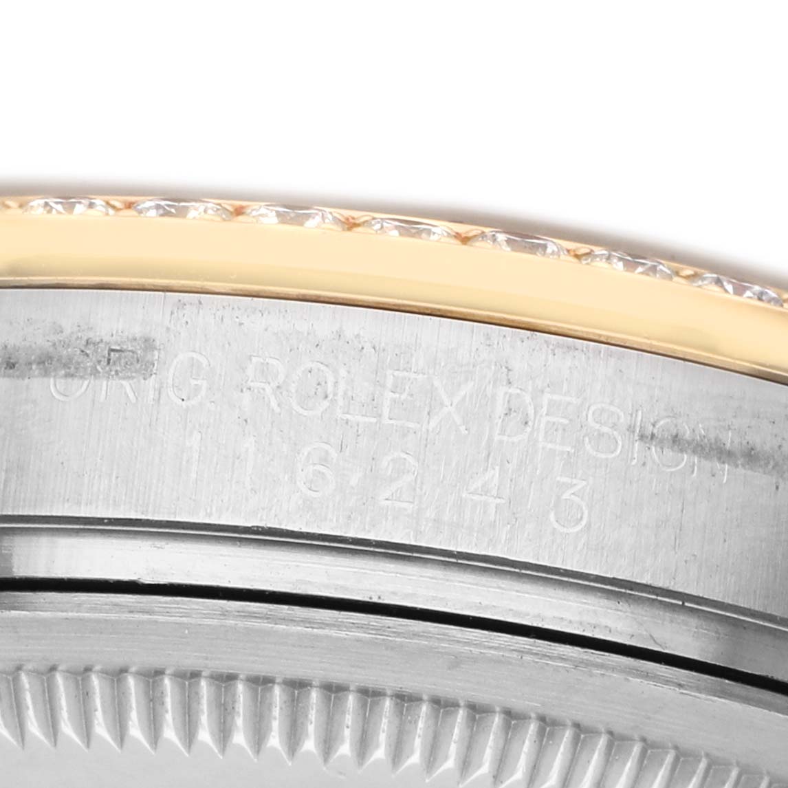 The image shows a close-up of the Rolex Datejust 116243 Men's Stainless Steel Champagne Dial watch casing, focusing on the engraved model number and the edge of the bezel.