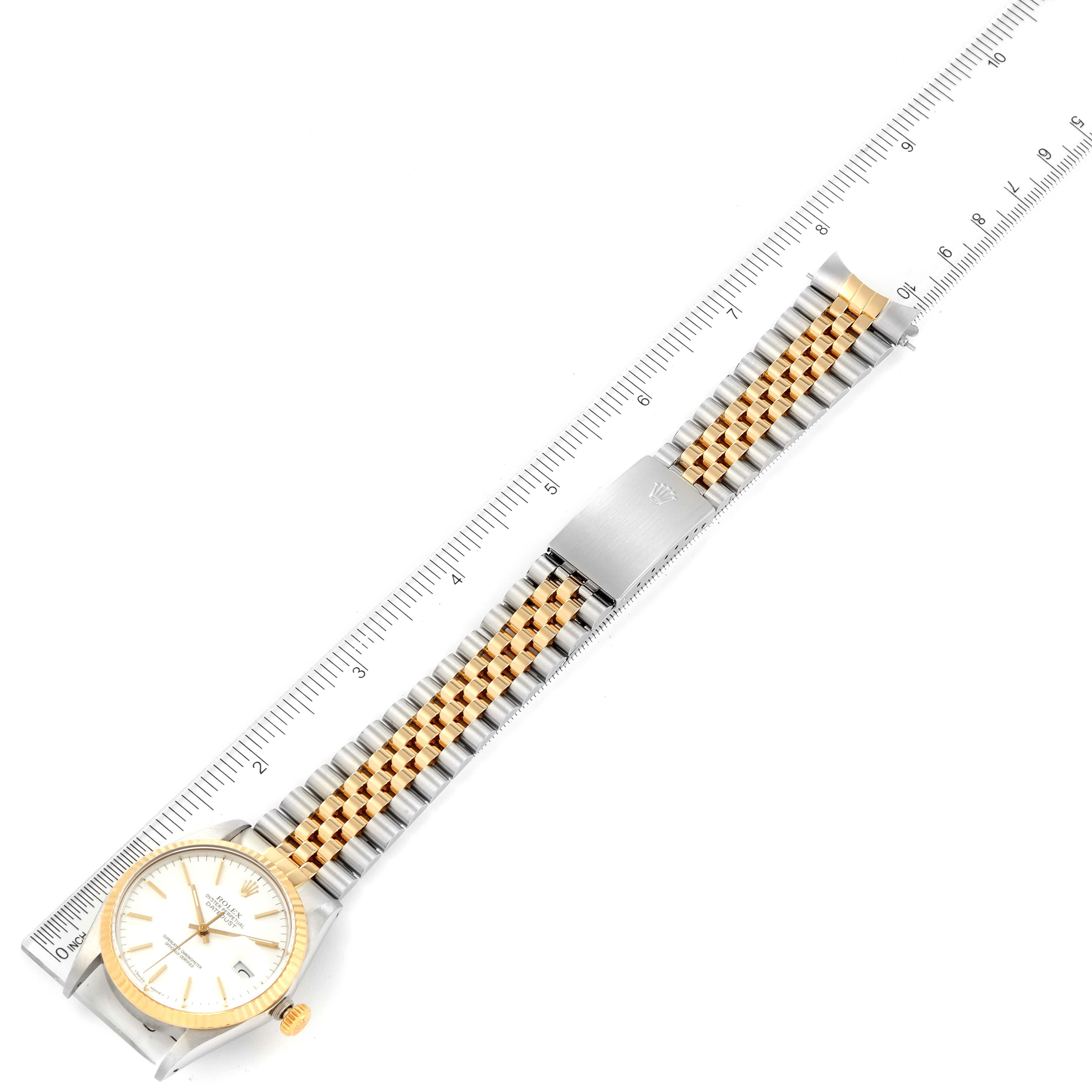 The Rolex Vintage Collection 16013 Men's Steel and Gold (two tone) White Dial 16013 Men's Steel and Gold (two tone) White Dial watch is displayed flat with a ruler beside it, showing the face, bracelet, and clasp at a top-down angle.