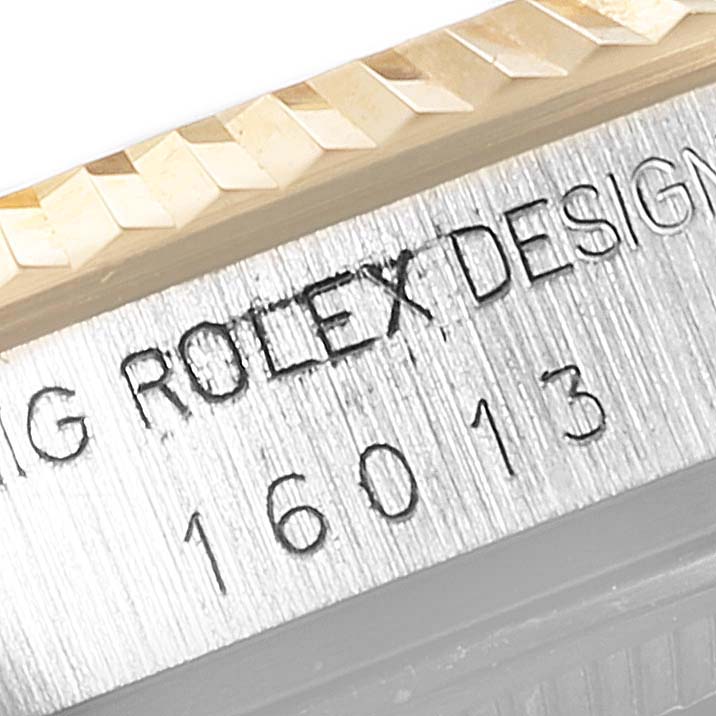 This image shows a close-up view of the bezel and case of a Rolex Vintage Collection 16013 Men's Steel and Gold (two tone) White Dial 16013 Men's Steel and Gold (two tone) White Dial watch, including engraved details.