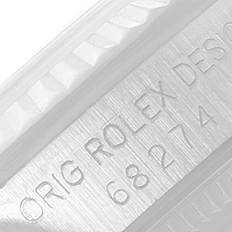 This image shows a close-up shot of the side engraving on a Rolex Mid-Size 68274 Women's Stainless Steel Blue Dial 68274 Women's Stainless Steel Blue Dial watch.