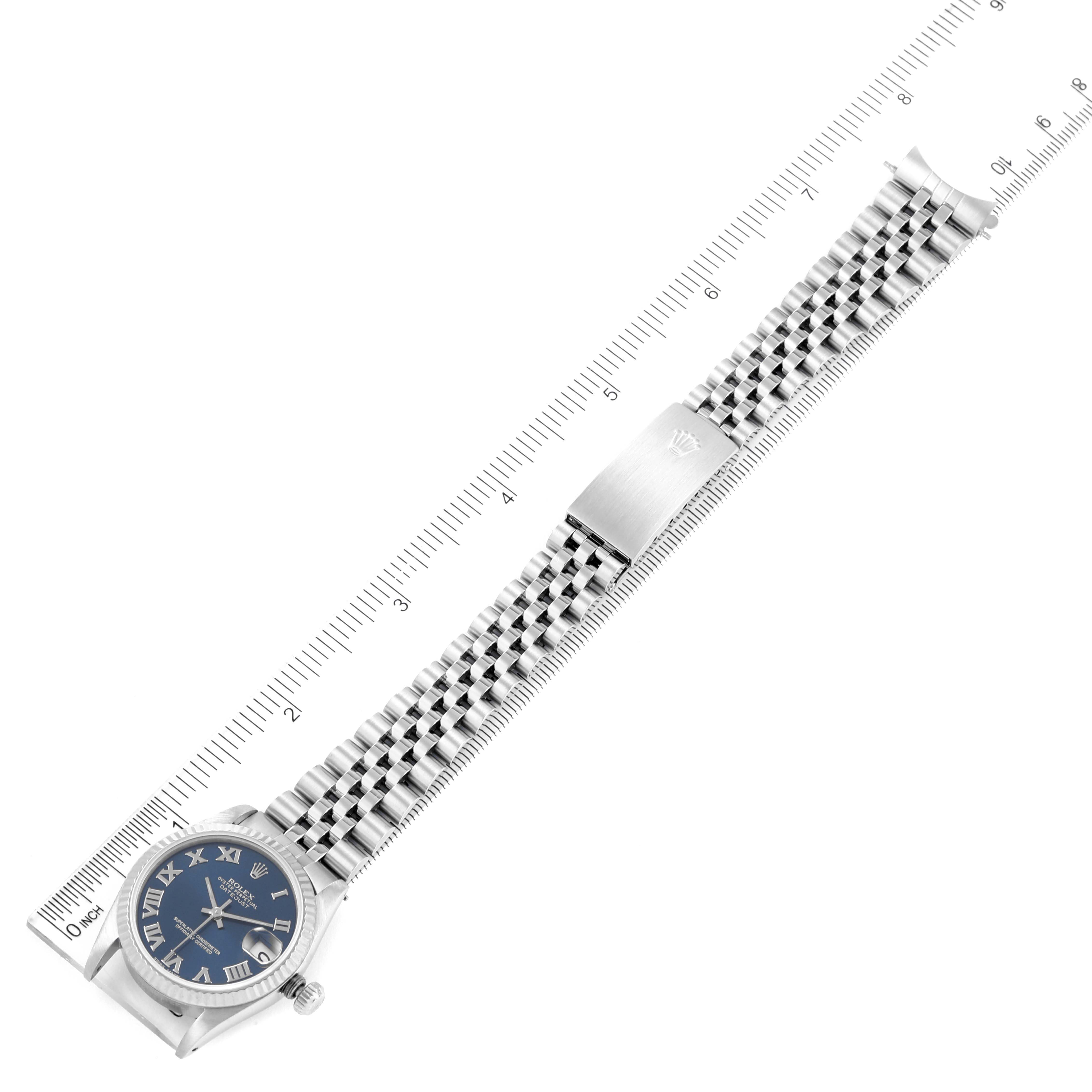 The image shows a Rolex Mid-Size 68274 Women's Stainless Steel Blue Dial 68274 Women's Stainless Steel Blue Dial watch in a top-down angle, displaying the dial, bracelet, and clasp, along with a ruler for scale.