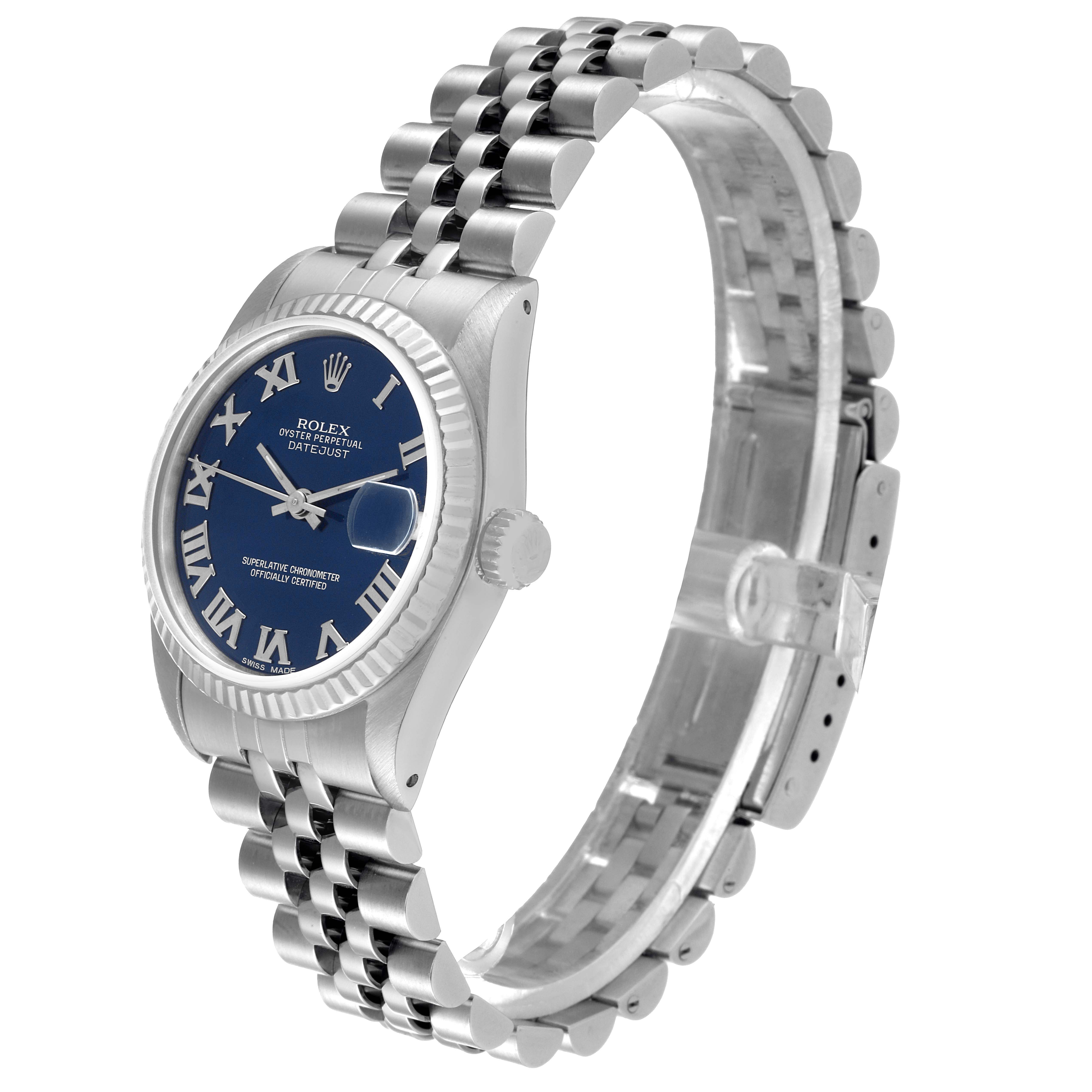 The image shows a Rolex Mid-Size 68274 Women's Stainless Steel Blue Dial 68274 Women's Stainless Steel Blue Dial Datejust from a three-quarter angle, highlighting its blue face, fluted bezel, and Jubilee bracelet.