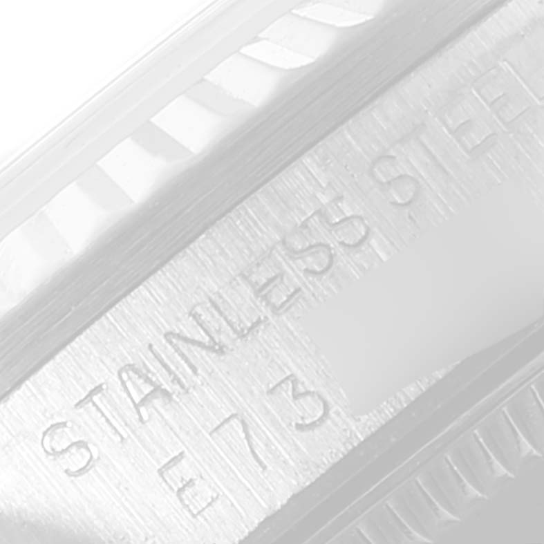 The image shows a close-up of the side of a Mid-Size Rolex watch case, highlighting the "STAINLESS STEEL" engraving.