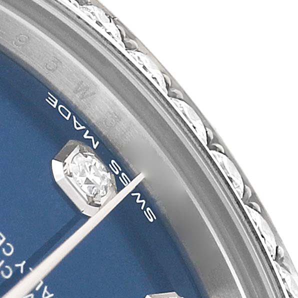 The image shows a close-up of the Rolex Datejust 178384 Women's Stainless Steel Blue Dial, highlighting the bezel, markers, and a portion of the hands.