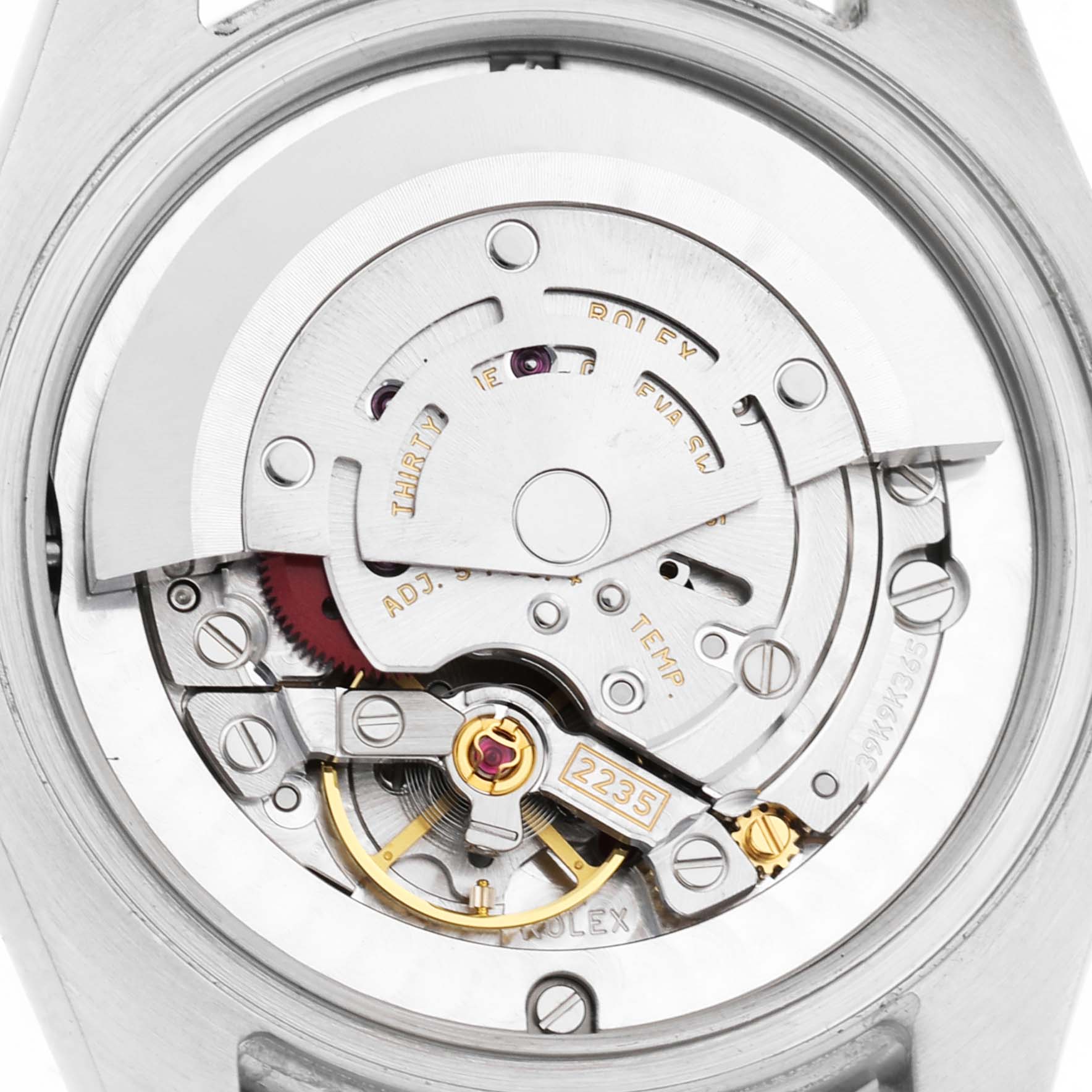 The image shows a close-up of the movement mechanism of a Rolex Datejust 178384 Women's Stainless Steel Blue Dial watch, highlighting its intricate interior components.