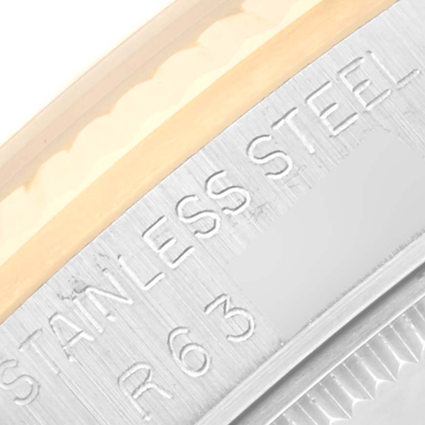 This close-up image shows the engraved side of a stainless steel Mid-Size Rolex watch case.