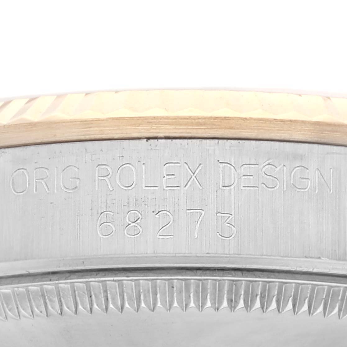 The image shows the side engraving of a Rolex Mid-Size 68273 Women's Steel and Gold (two tone) Champagne Dial 68273 Women's Steel and Gold (two tone) Champagne Dial model, featuring "ORIG ROLEX DESIGN 68273" on the case.