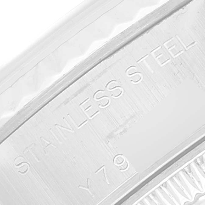 The image shows a close-up of the engraved stainless steel part of a Rolex Datejust 79174 Women's Stainless Steel Mother of Pearl Dial 79174 Women's Stainless Steel Mother of Pearl Dial watch.