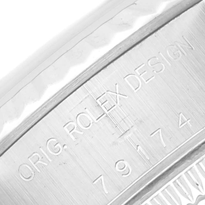 The image shows a close-up of a Rolex Datejust 79174 Women's Stainless Steel Mother of Pearl Dial 79174 Women's Stainless Steel Mother of Pearl Dial model's side case, displaying the engraved text “ORIG. ROLEX DESIGN.”