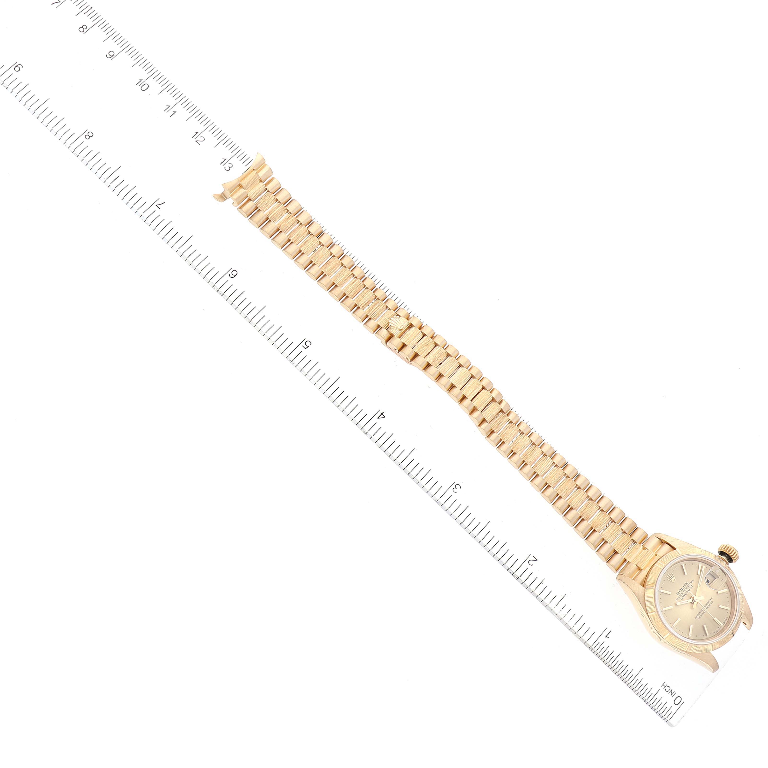 The image shows a Rolex President 69278 Women's Yellow Gold Champagne Dial 69278 Women's Yellow Gold Champagne Dial model watch laid flat, with a ruler alongside to measure its band and dial.